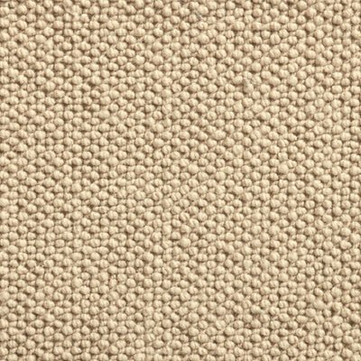 Close-up view of a textured beige fabric surface with small, round bumps.