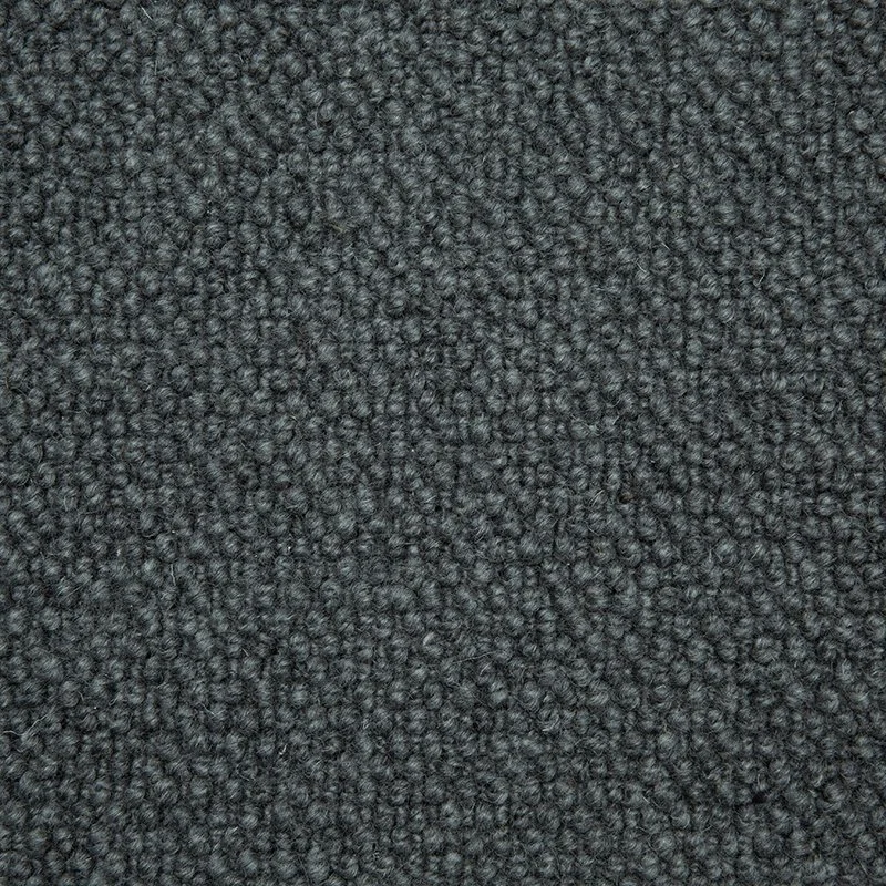 Close-up photo of dark gray textured fabric or carpet fibers.