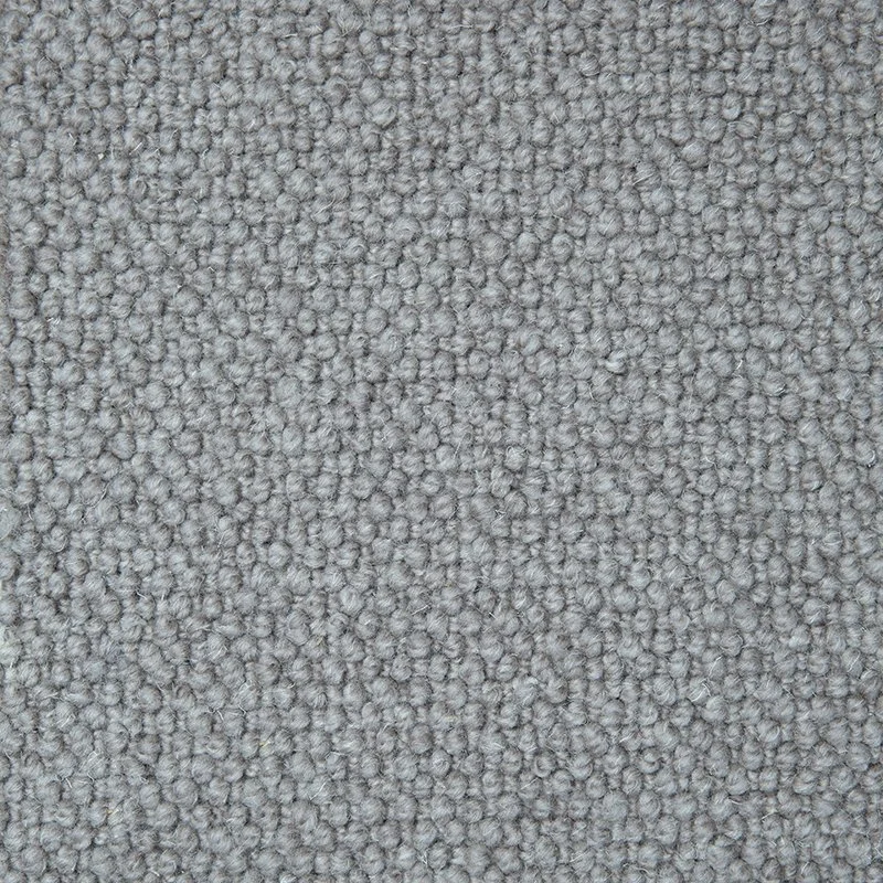 Close-up view of textured gray carpet fibers.