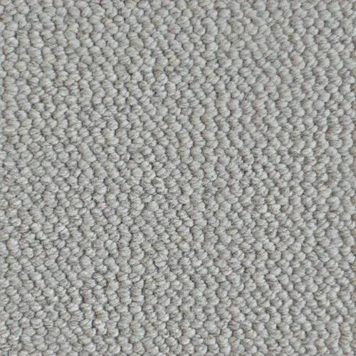 Close-up of a beige textured carpet with small looped fibers.
