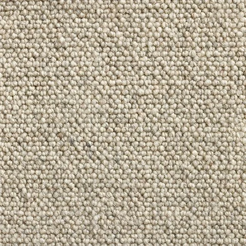 Close-up of beige carpet with small, tightly woven fibers.