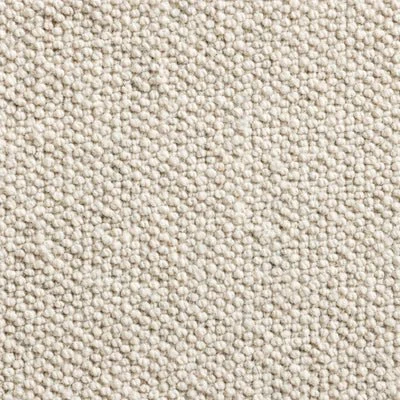 Close-up of a textured beige fabric with small raised dots.