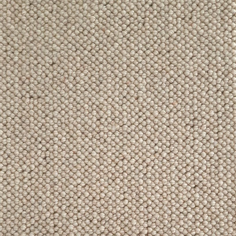 Close-up of beige textured carpet with small, tightly woven loops.