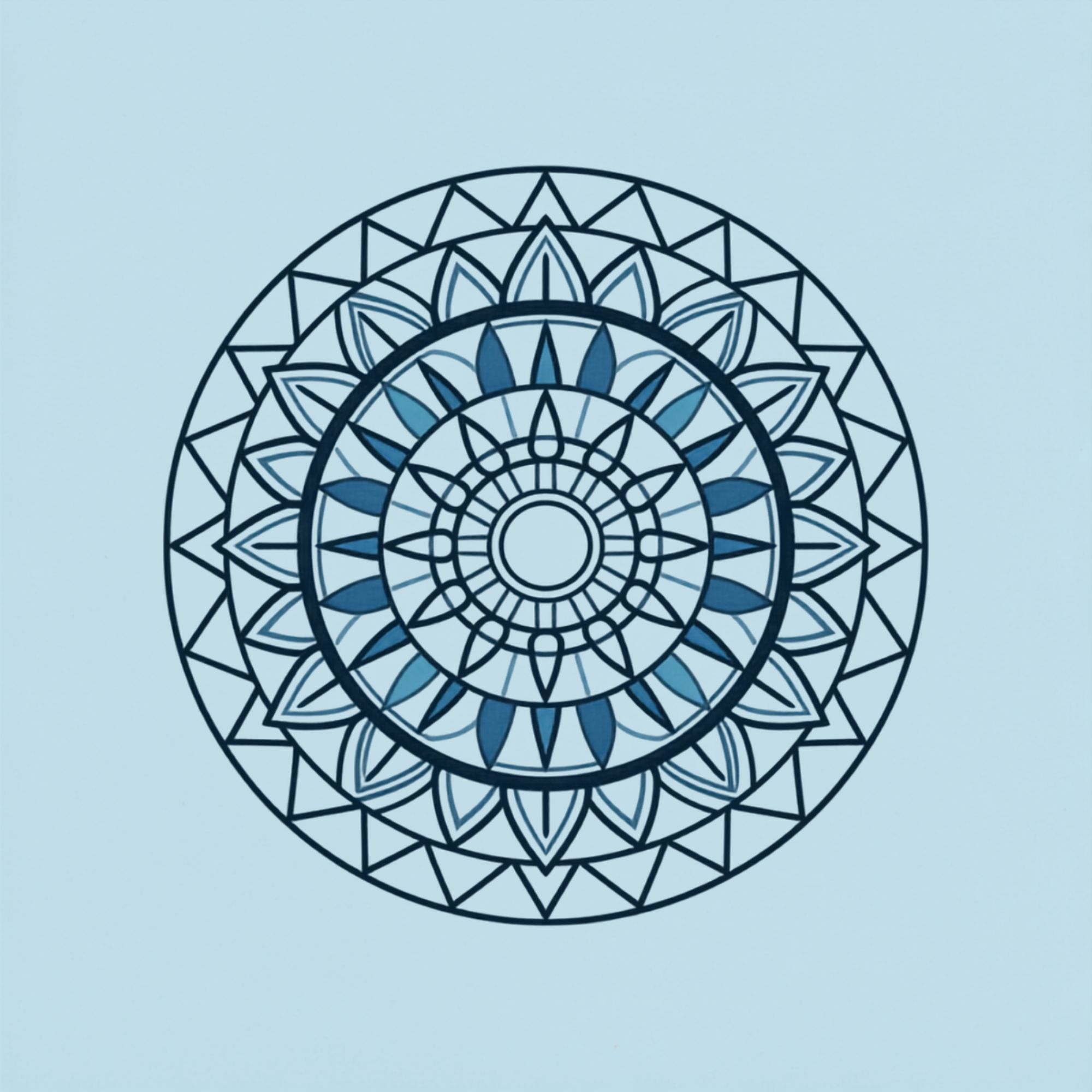 Close-up of a black and blue geometric mandala design on a light blue background.