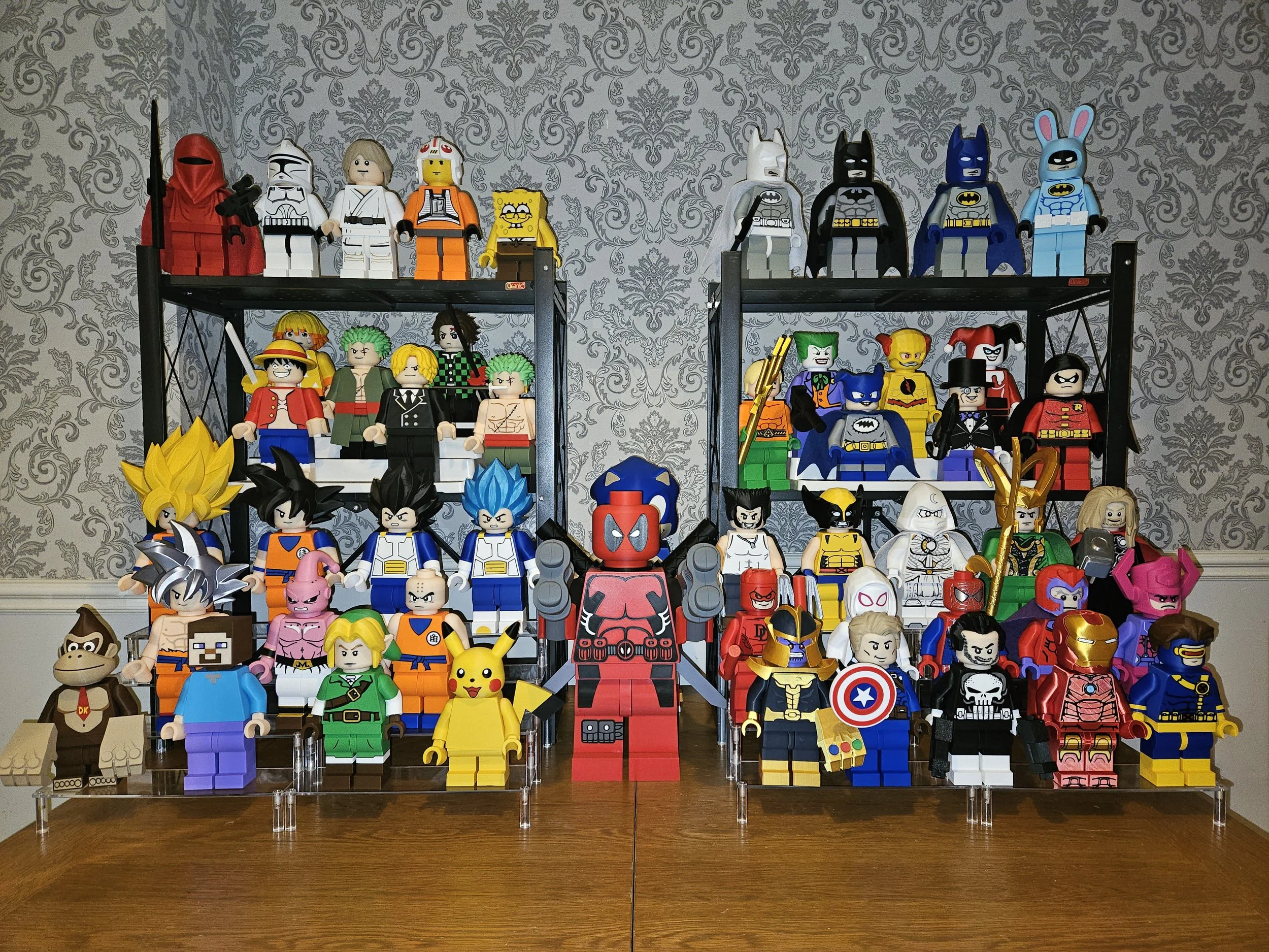 A large collection of LEGO figurines of various characters from popular movies and comics, displayed on tiered shelves against a decorative wallpapered wall.