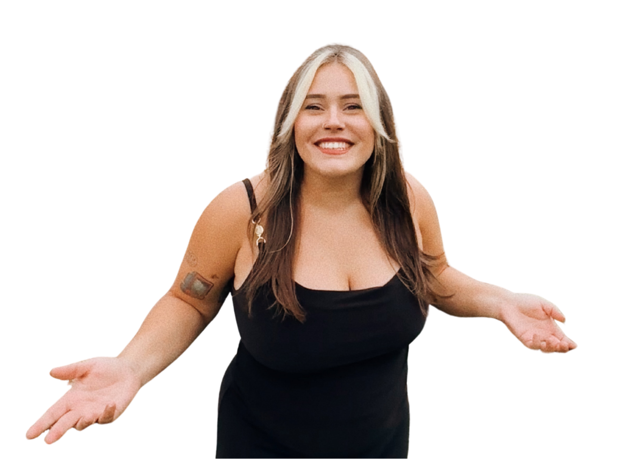 A woman with long brown hair and blonde highlights, wearing a black top, smiling with arms outstretched, in front of a red and purple background.
