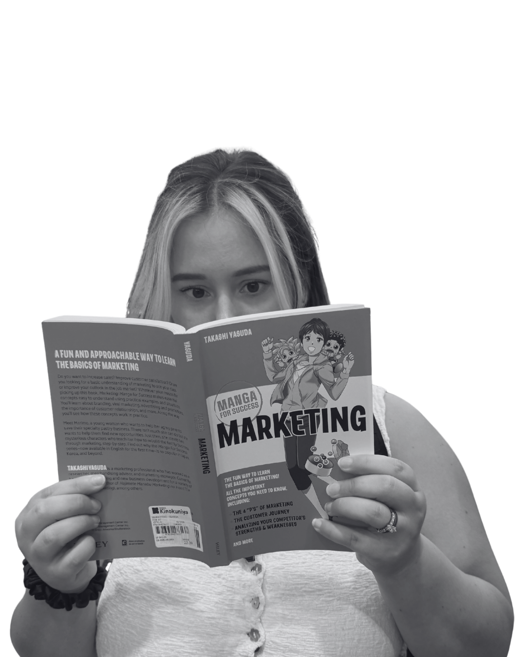 A woman with light hair, wearing a white sleeveless top, is reading a book titled 'Marketing' by Takashi Yasuda. The book cover features cartoon characters and marketing concepts.
