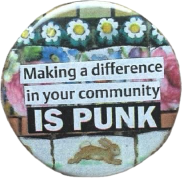 Sticker with flowers and a message: "Making a difference in your community IS PUNK", featuring a small animal silhouette at the bottom.