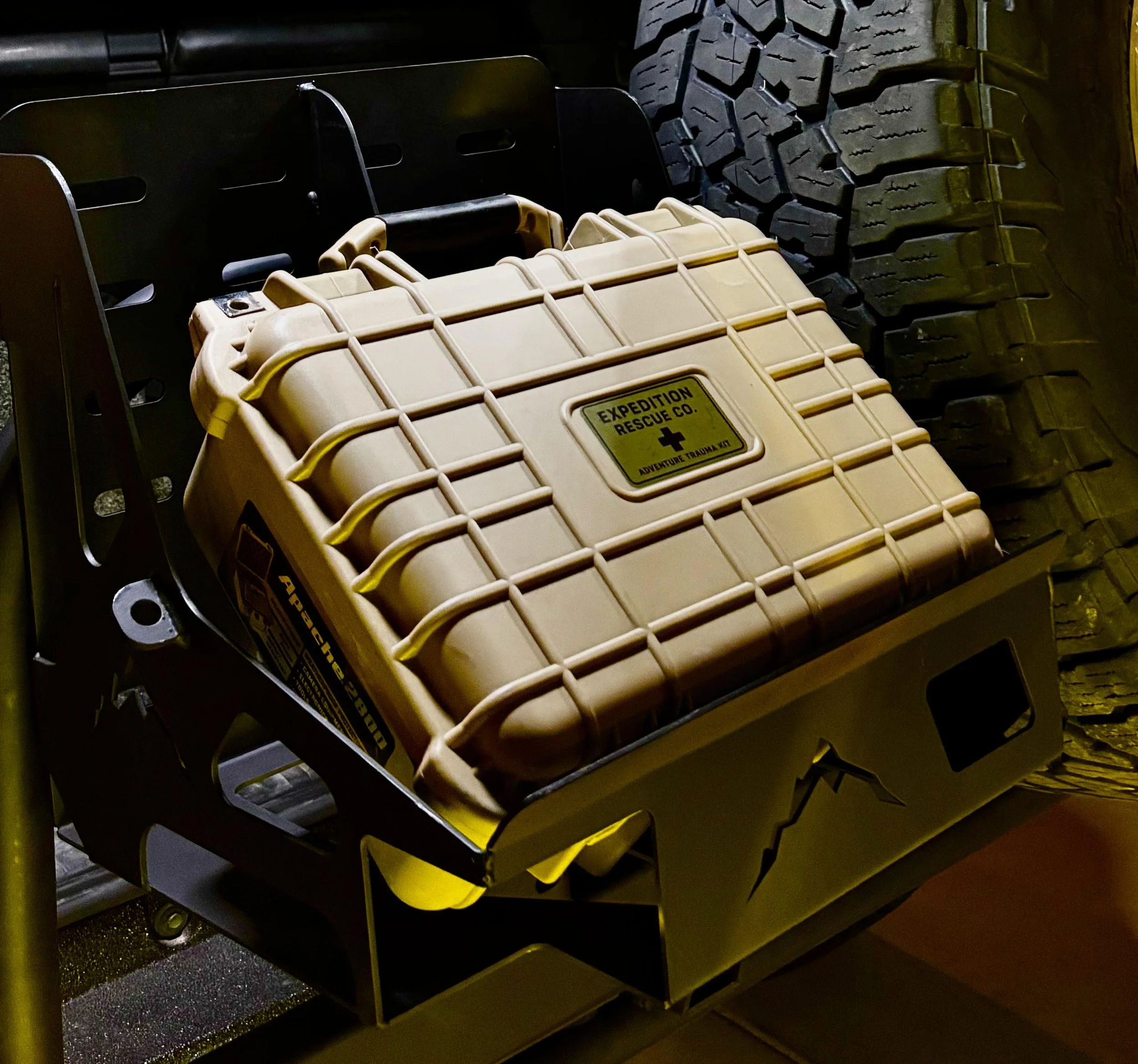 Stacked plastic rescue containers with yellow handles and treaded rubber tires on dark surface.