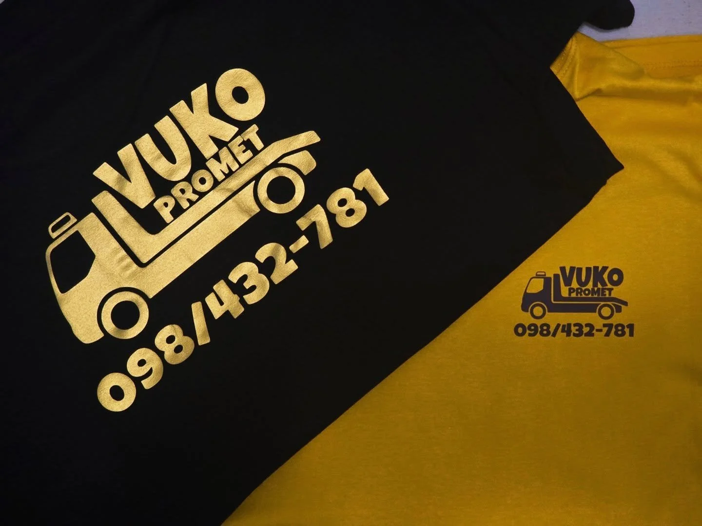 Black and yellow shirts with Vuko Promet logo and phone number printed on them.