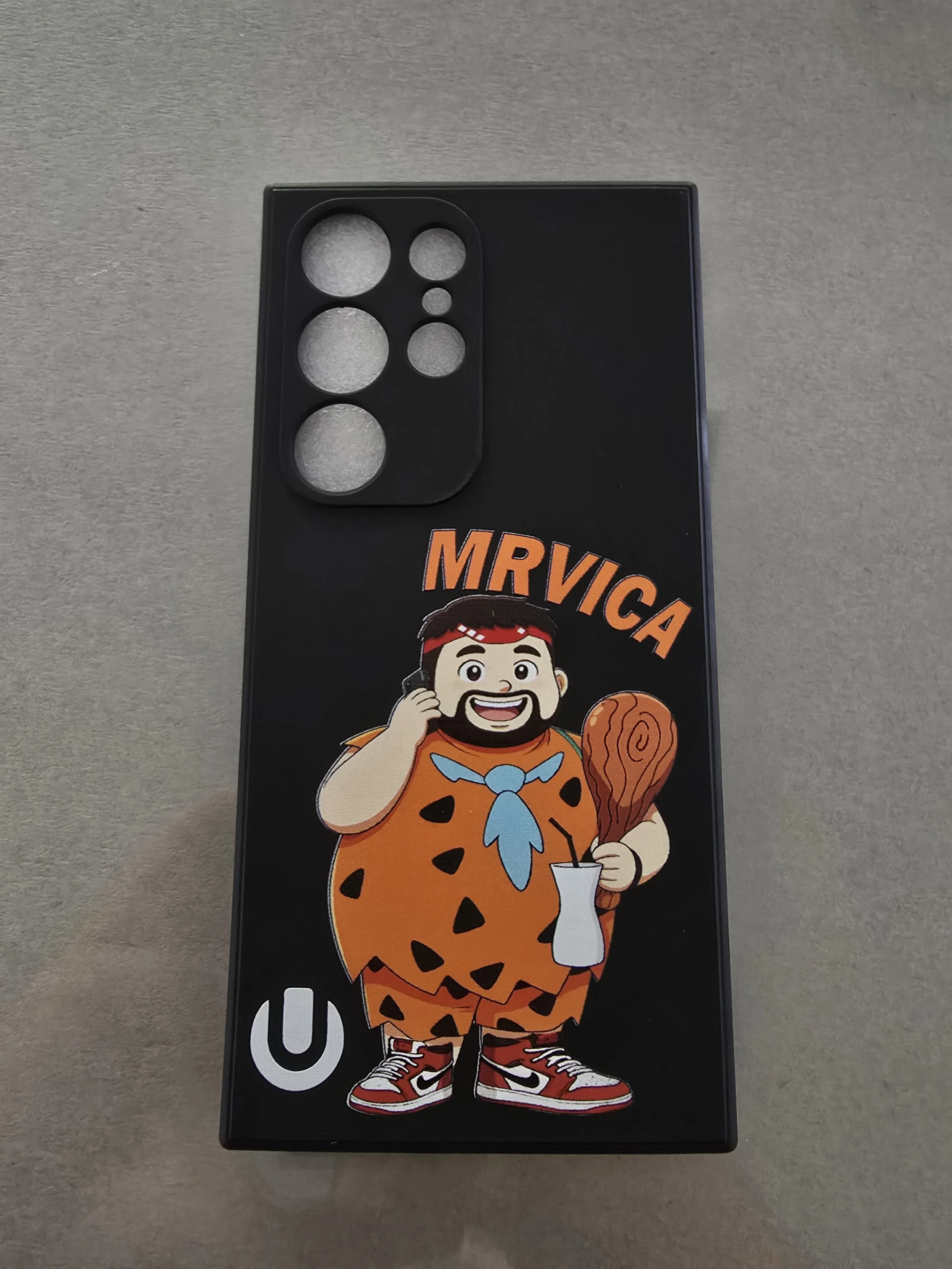A tablet case featuring a cartoon character of a person dressed as Fred Flintstone from The Flintstones, holding a drumstick and a drink, and wearing red sneakers and a blue necktie.