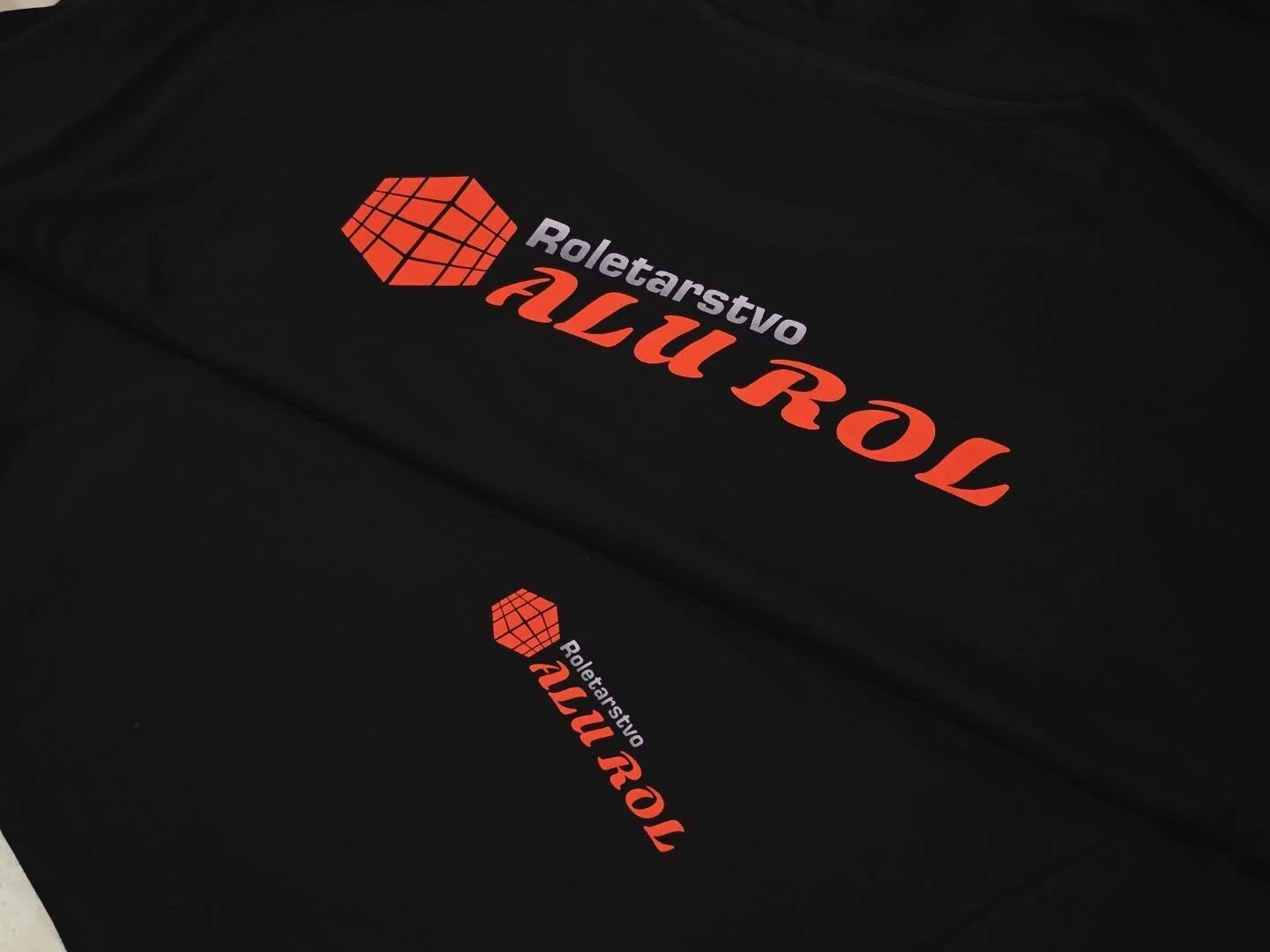 Black box with a red geometric logo and red and white text that reads 'Roletarstvo ALU ROL'.