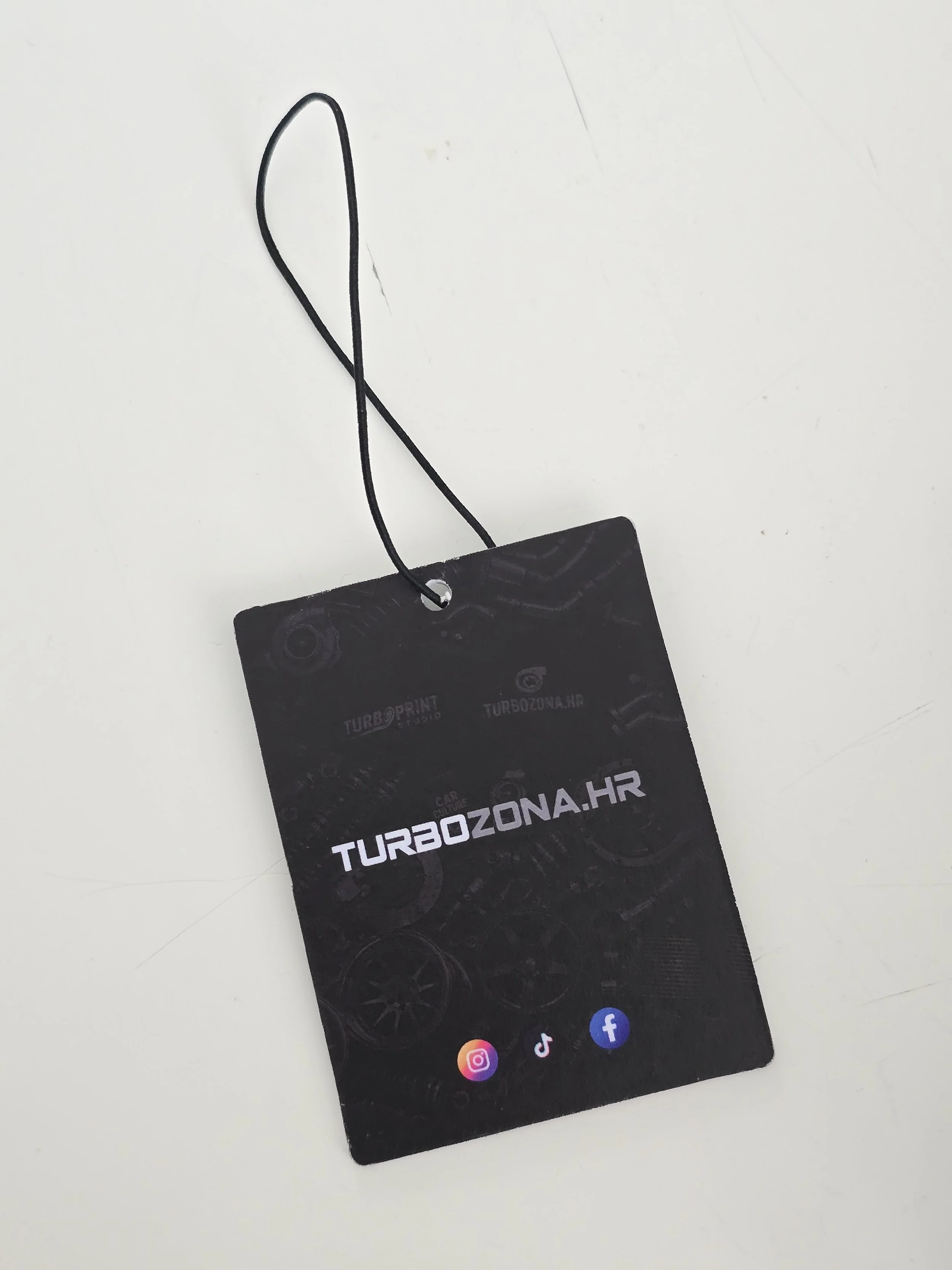 Business card from Turbozona.hr with social media icons for Instagram, TikTok, and Facebook on a white surface.