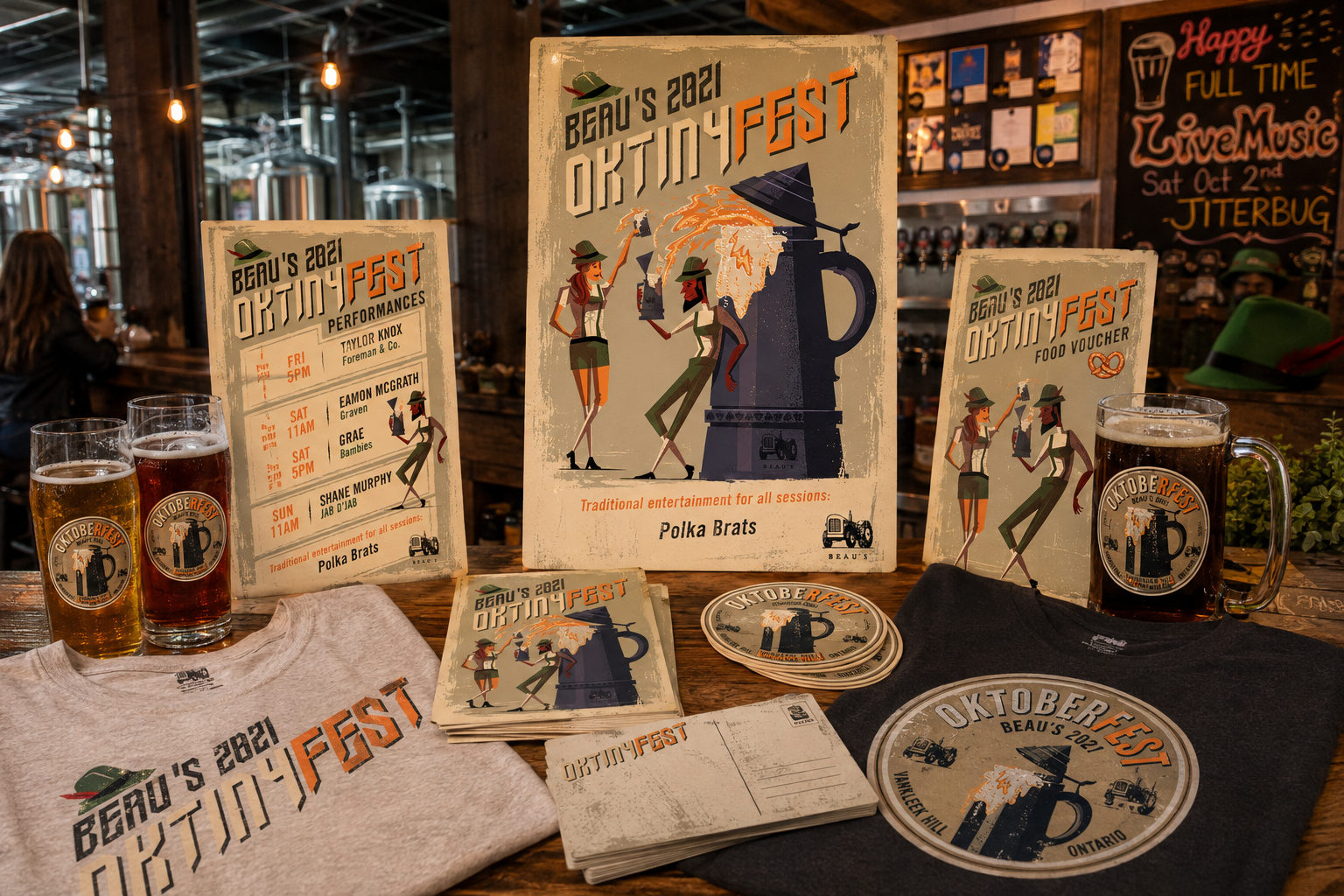 Table with promotional materials and beverages for event, including posters, stickers, beer mugs, and a T-shirt.