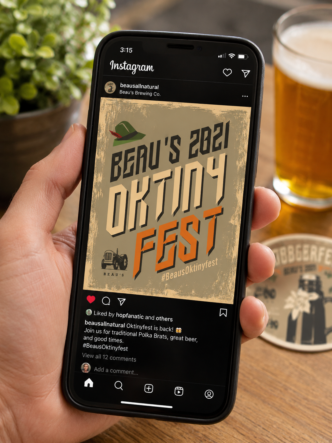 Hand holding a smartphone displaying an Instagram post with a background of a beer glass, a plate, and a potted plant on a wooden table.
