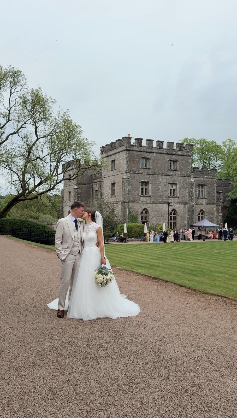 Couple kissing in front of castle venue