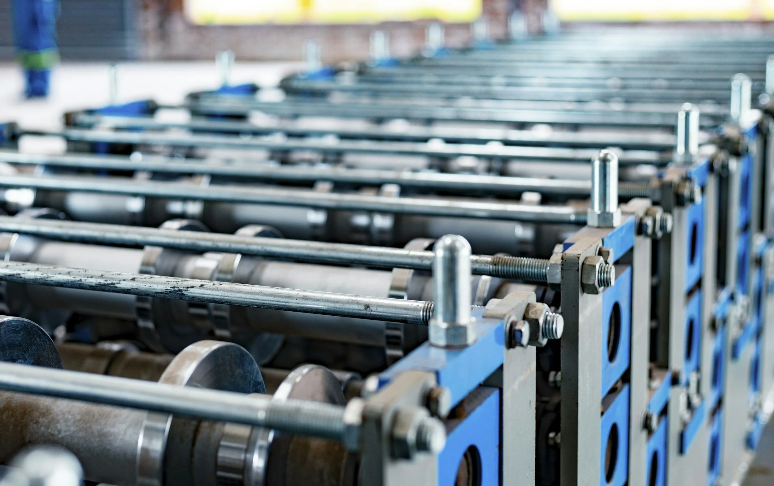 Industrial manufacturing equipment with precision rollers and shafts