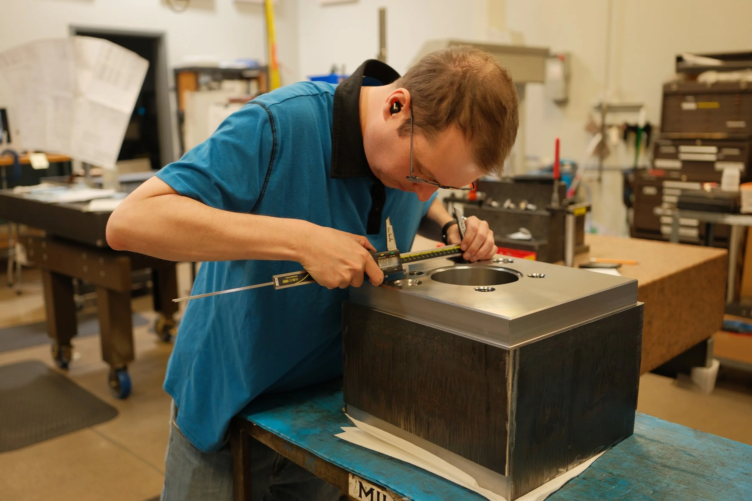 Clark Manufacturing quality technician inspecting a precision-machined component