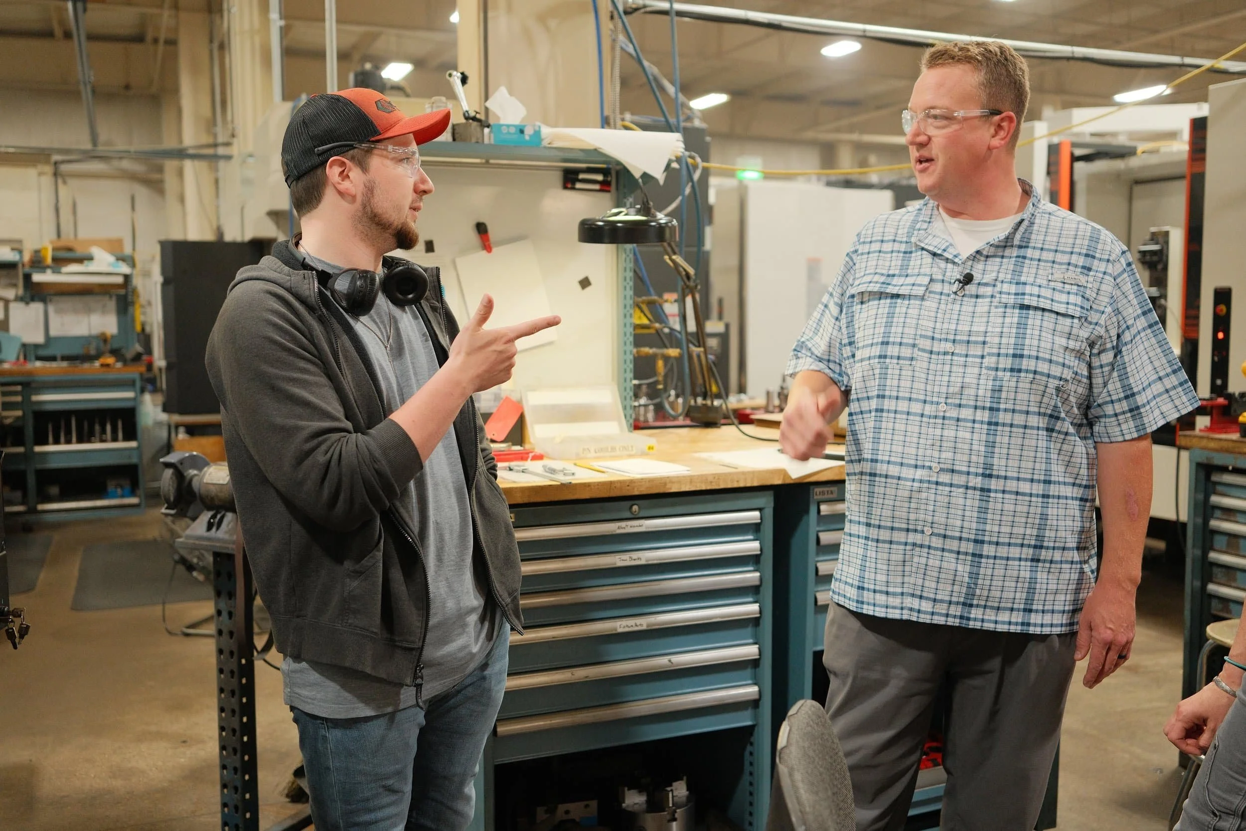 Clark Manufacturing team members discussing a machining project on the shop floor