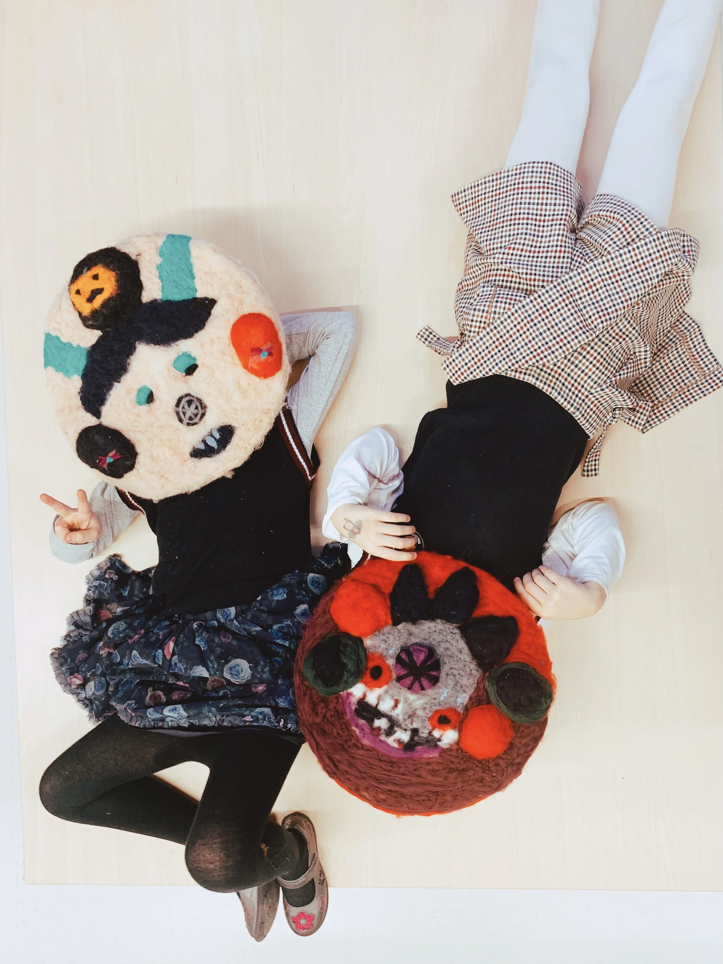 Two kids with their work in Rīdze wool felting class