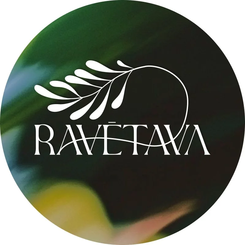 A logo with a white leaf design and the word 'RAVETAVA' in stylized white text on a dark, blurred background.