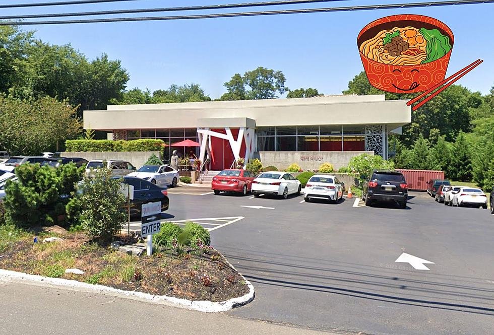 Parking lot and outside of a modern restaurant building with a large sign and umbrella seating, surrounded by trees. An illustration of a bowl of ramen is added in the top right corner.