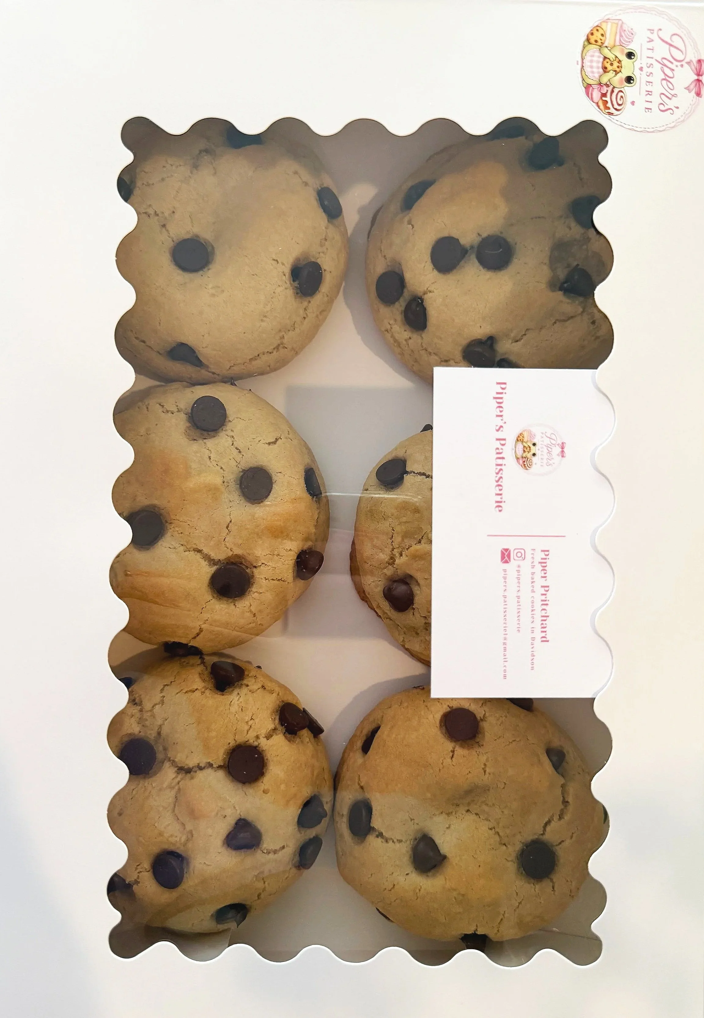 Box of chocolate chip cookies with visible chocolate chips.