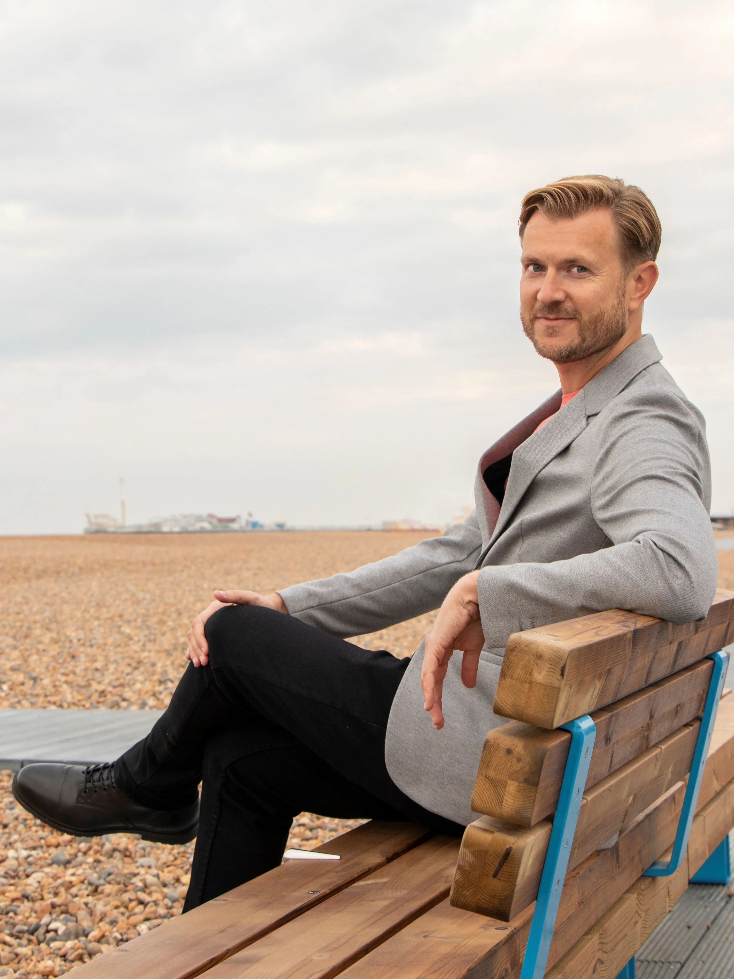 Will Harris, co-founder of Art MOT, sitting by the sea.