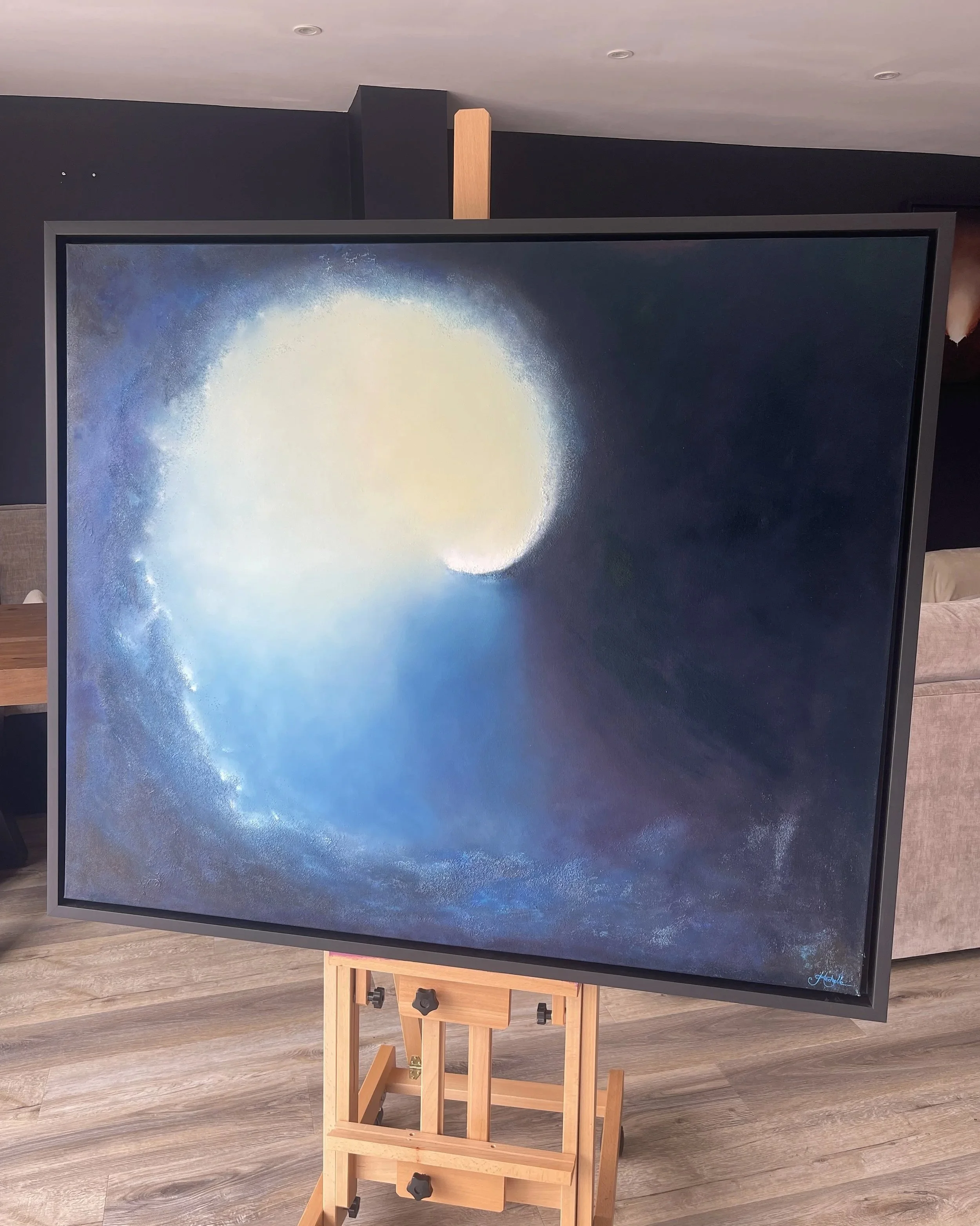 Emergence, atmospheric abstract oil painting by Mechelle Tebbs, featuring a luminous circular light appearing above powerful deep-blue forms.