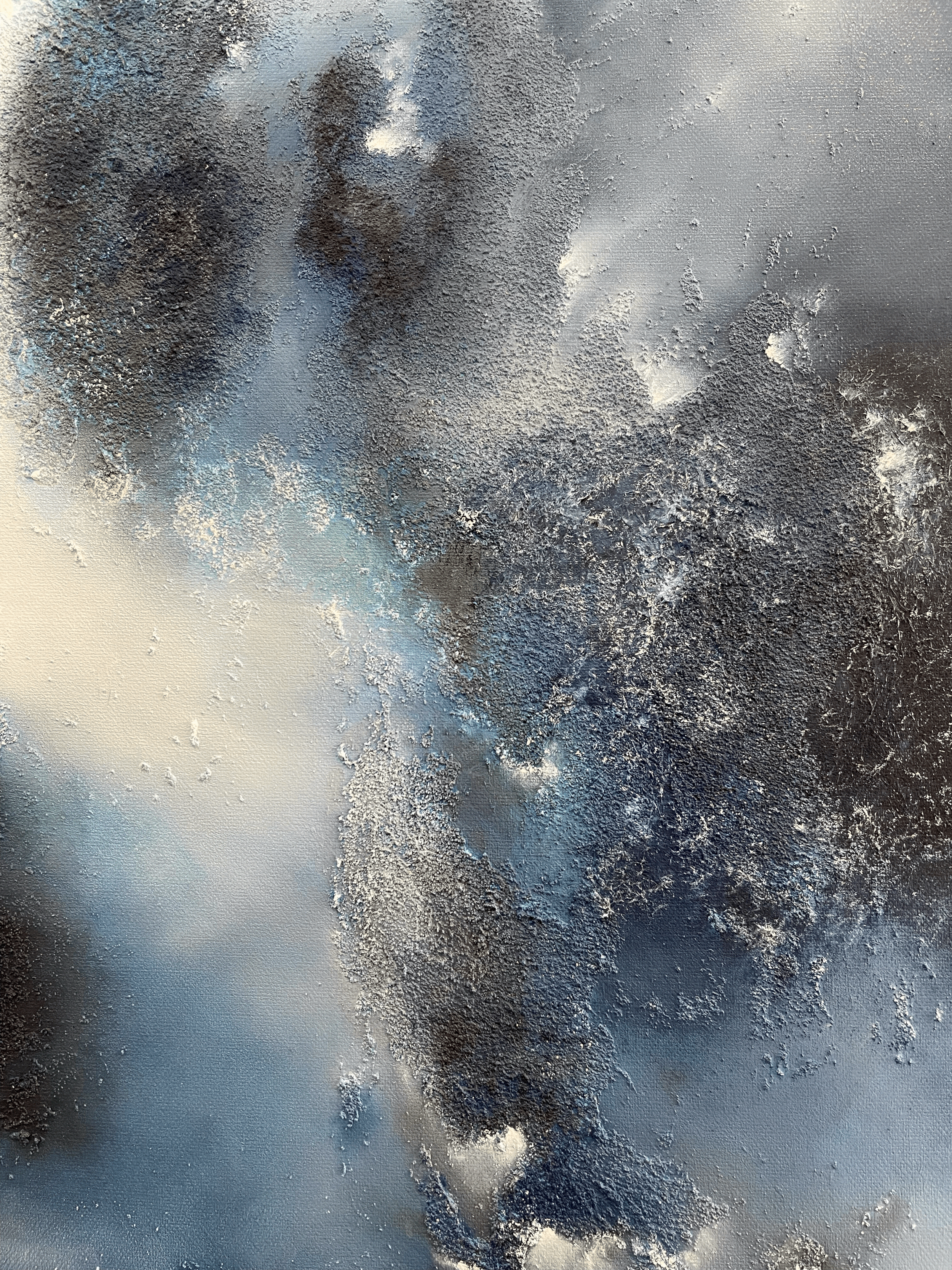 Close-up of a window with frost and ice crystals forming intricate patterns on the glass.