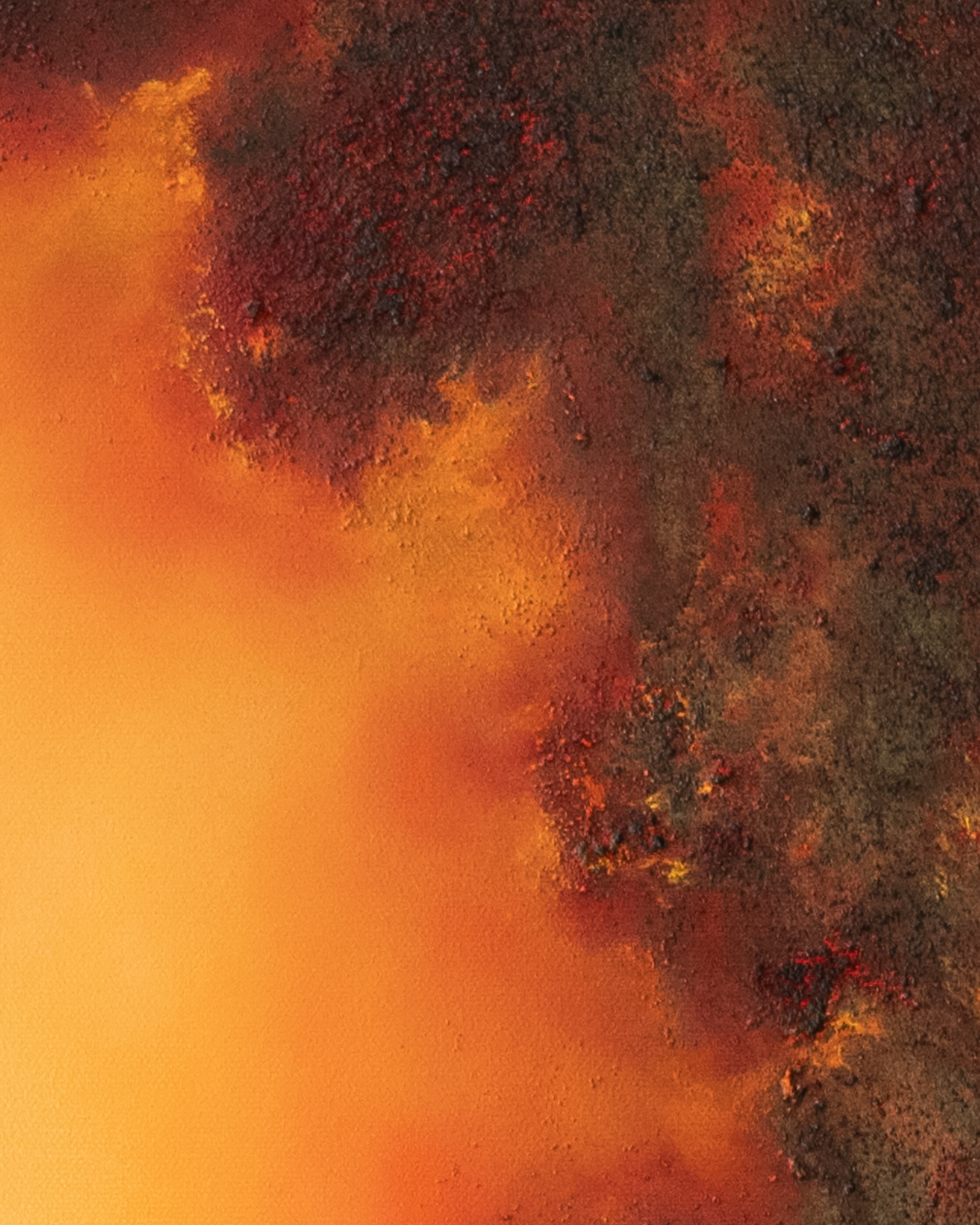 Close-up detail of Unbound, showing volcanic texture, deep dark pigments and vivid passages of orange, red and yellow light.