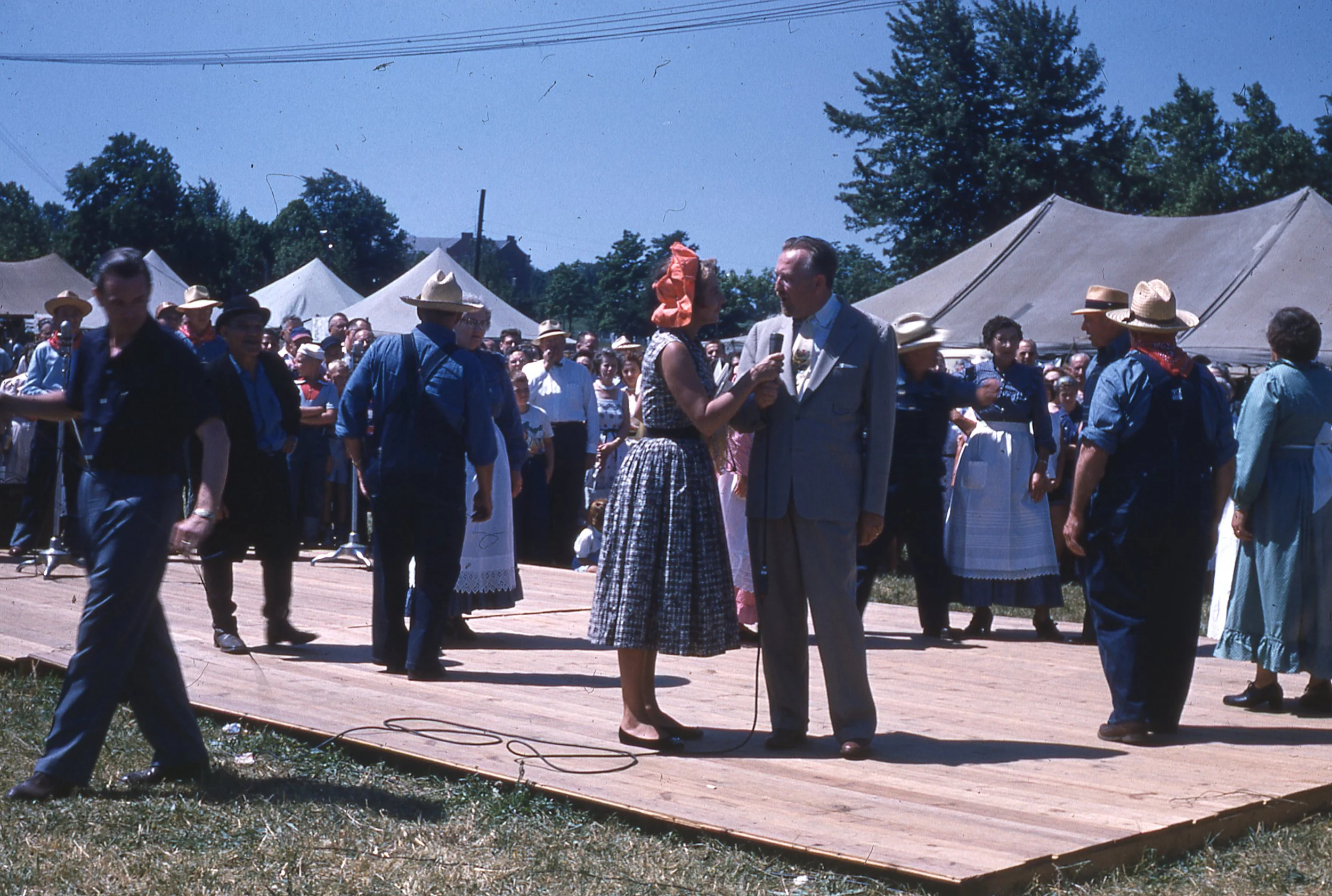 Arlene Francis interviewing Dr. Shoemaker on wooden outdoor stage.