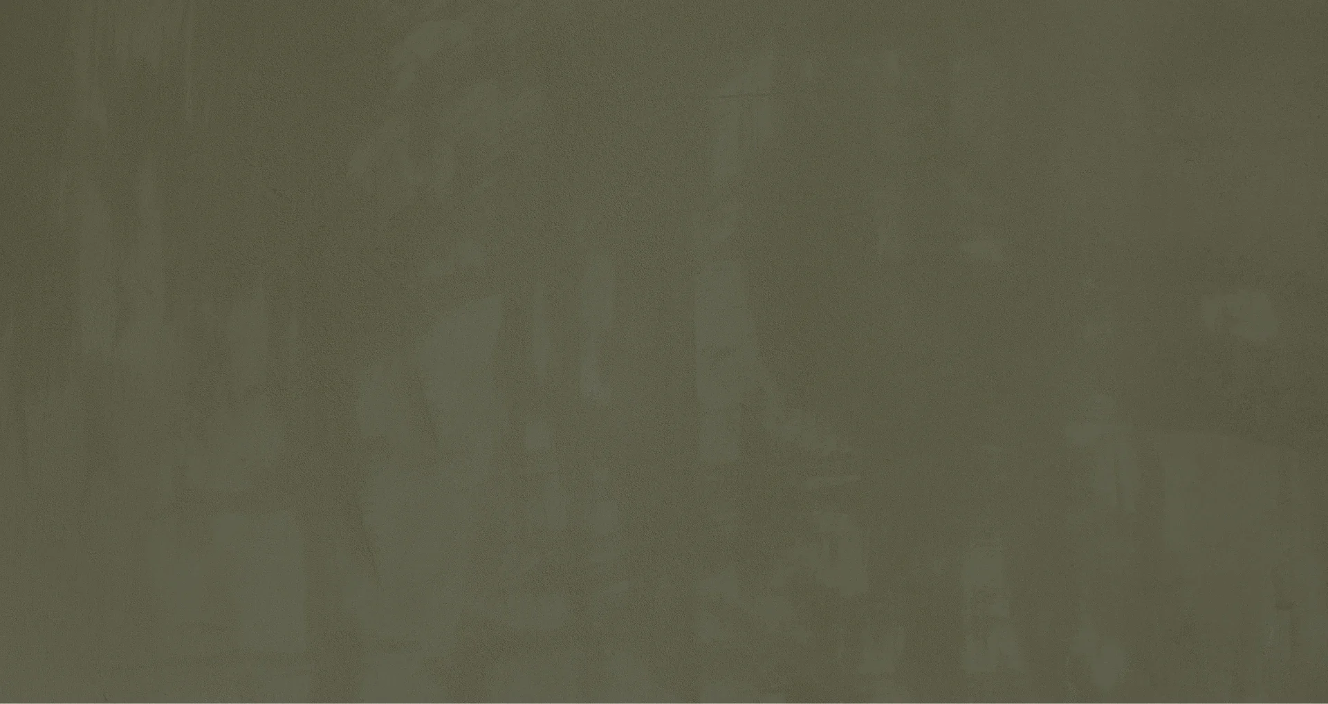 A blank greenish wall with some patches and marks, no distinct objects or features.