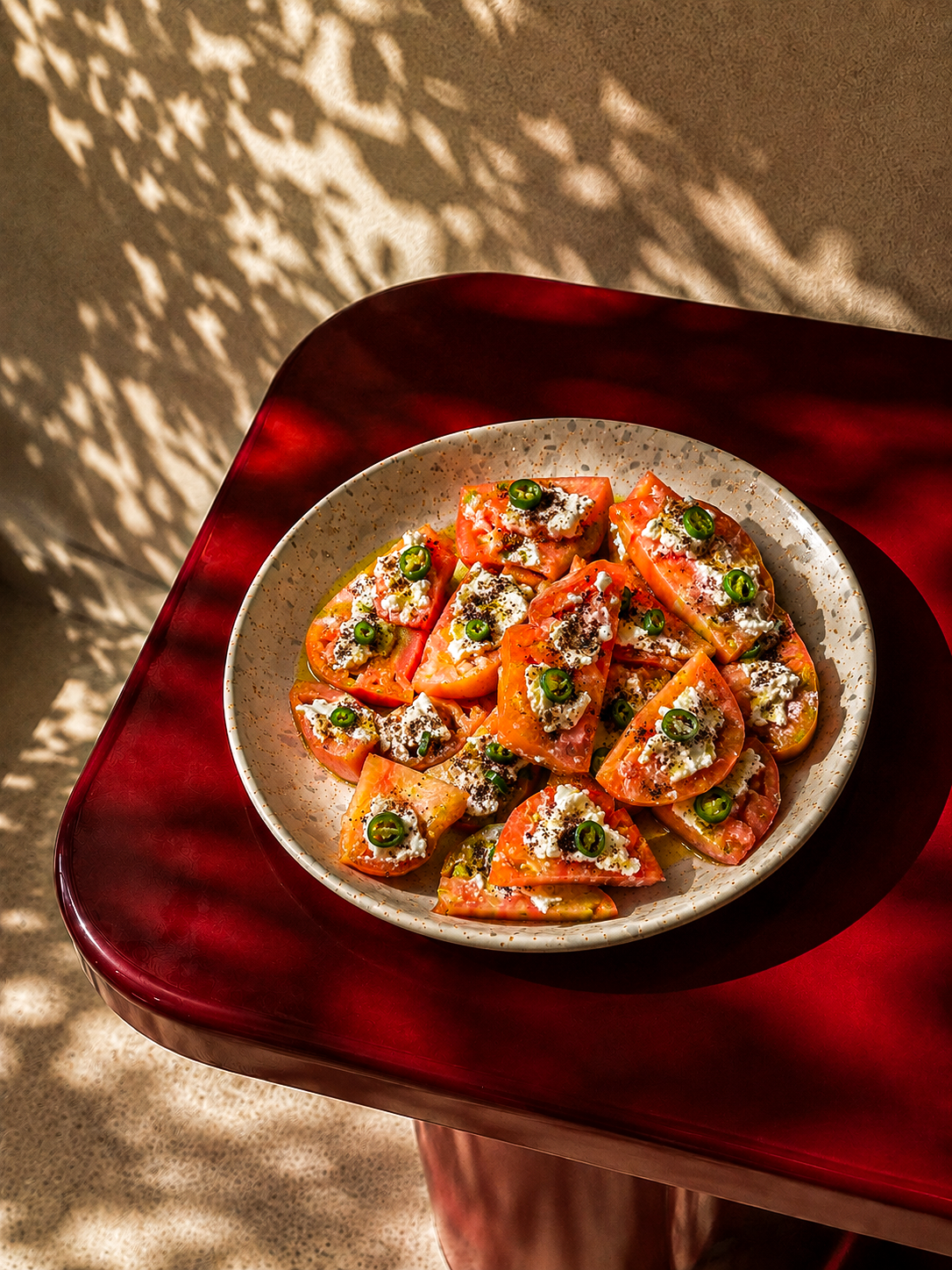 Seasonal Mediterranean tomato dish finished with herbs and extra virgin olive oil.