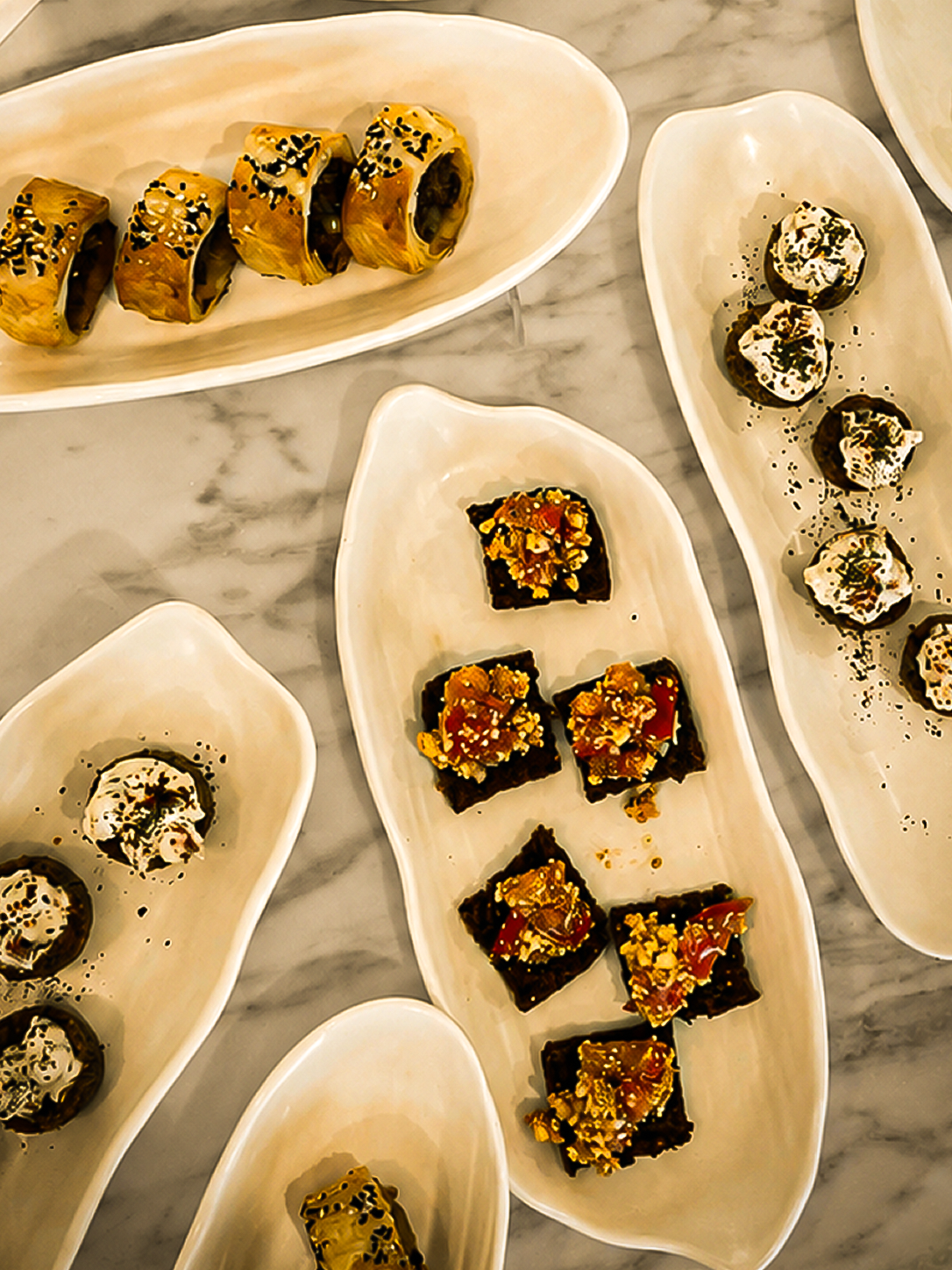 Mediterranean sharing plates served on handcrafted ceramics for a private client dining experience.