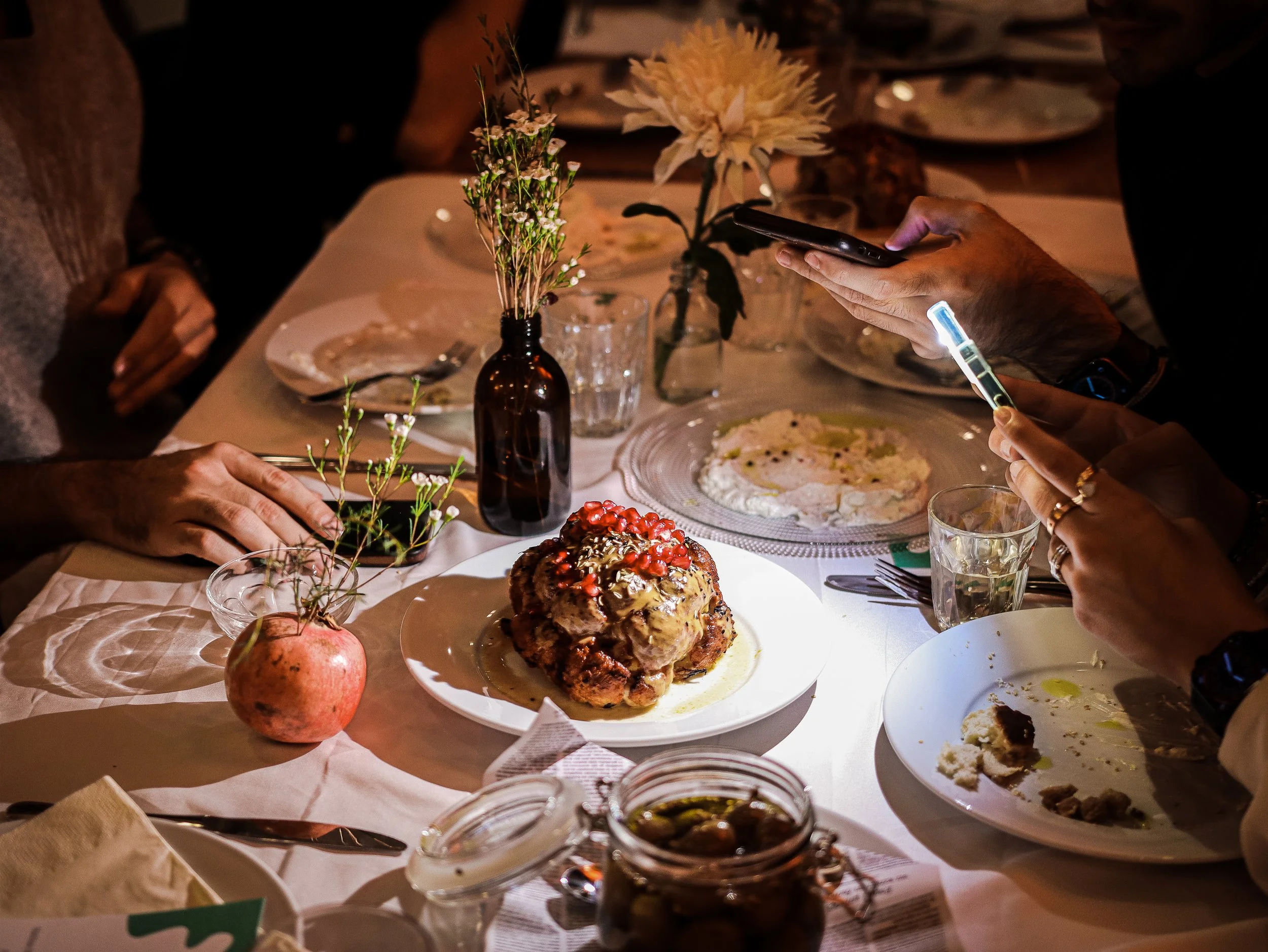 guests sharing a seasonal Mediterranean feast around the table designed by Monsieur Bou