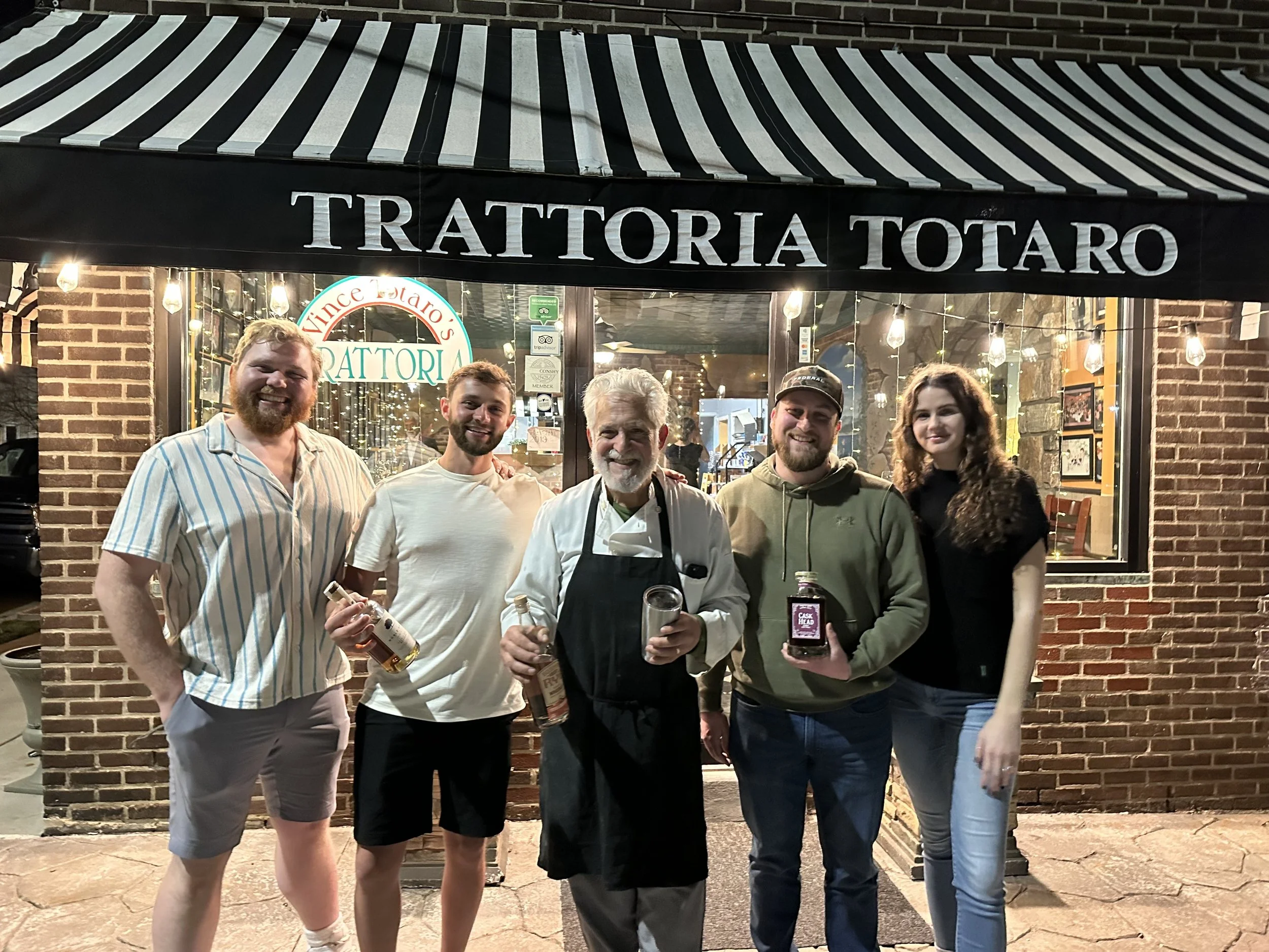 Members of the whiskey club smiling at an event