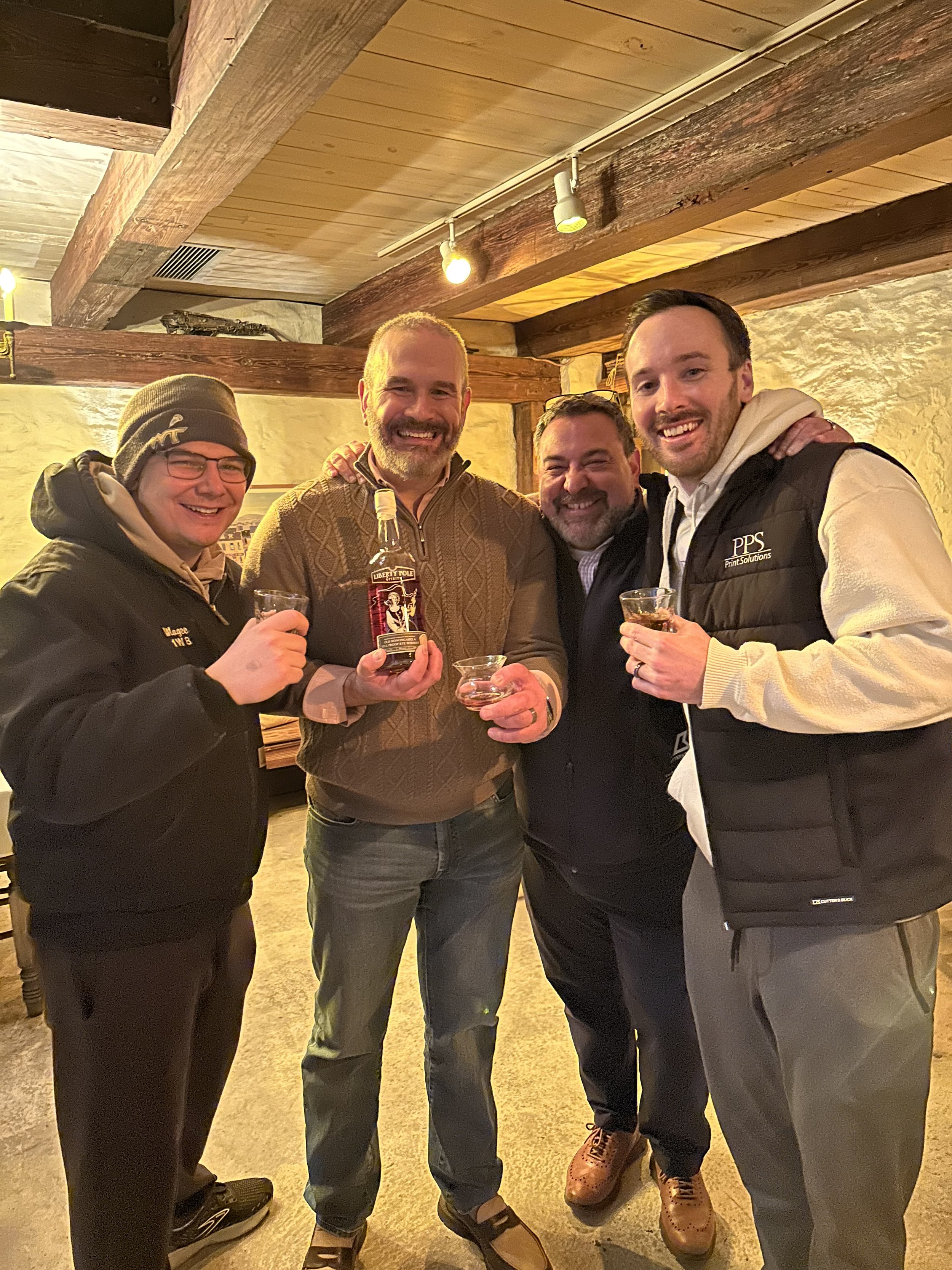 Members of the whiskey club smiling at an event