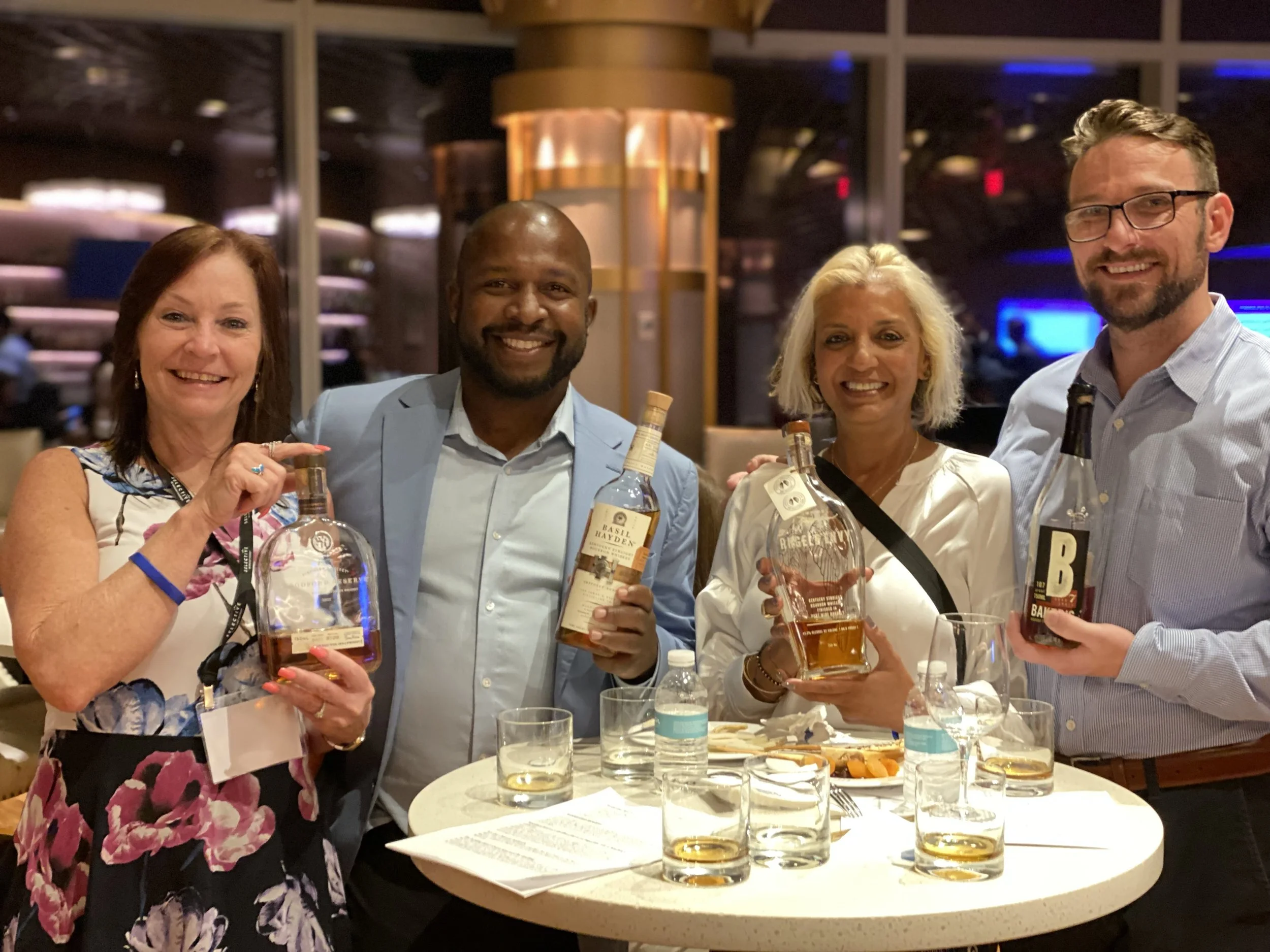 Members of the whiskey club smiling at an event
