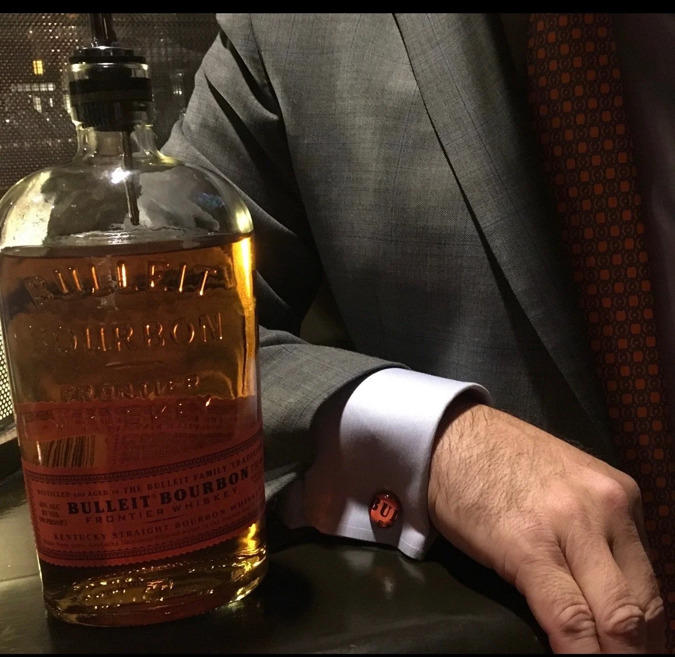 A bottle of whiskey next to the owner of Whiskey Links® & More