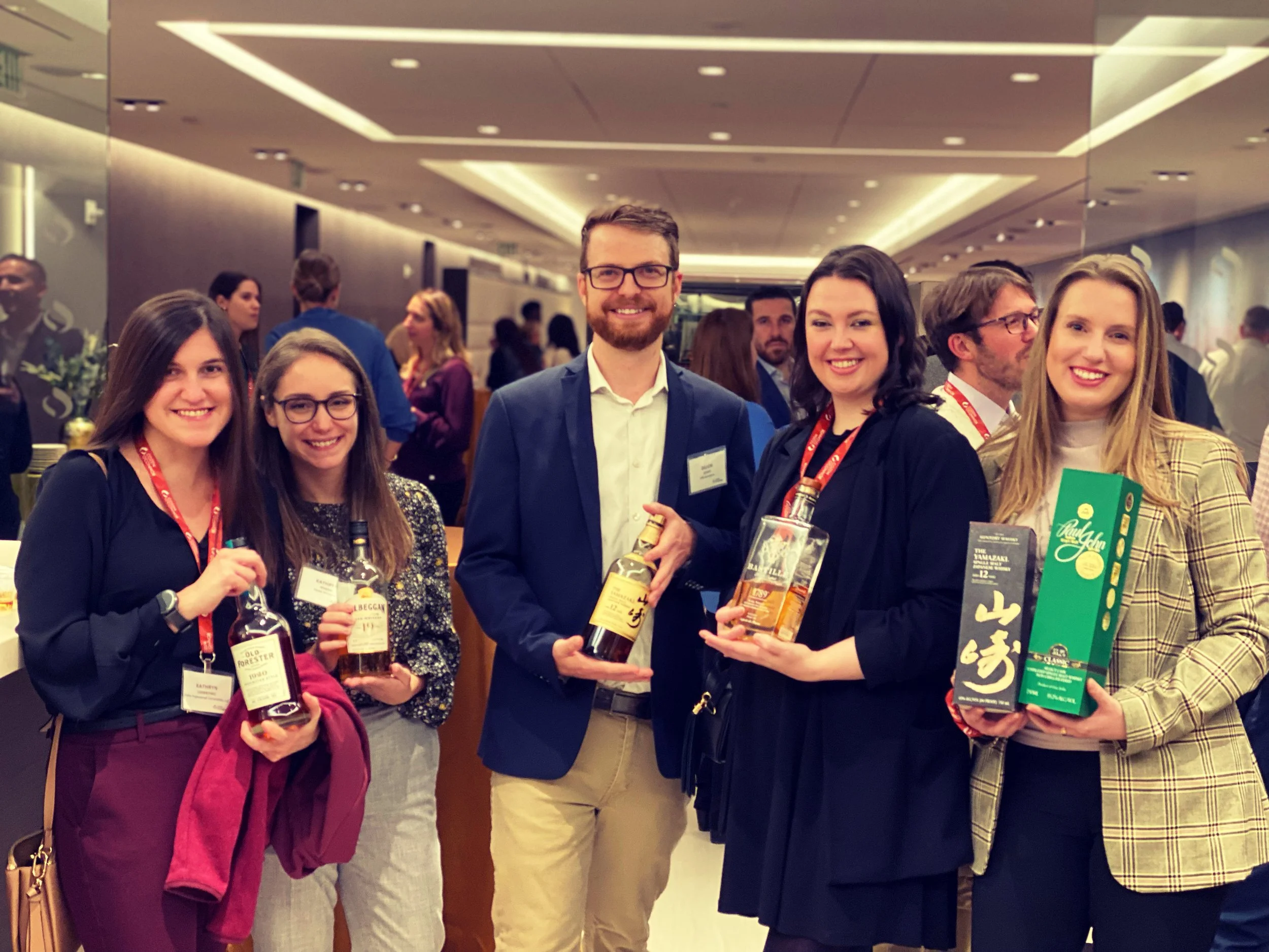 Members of the whiskey club smiling at an event