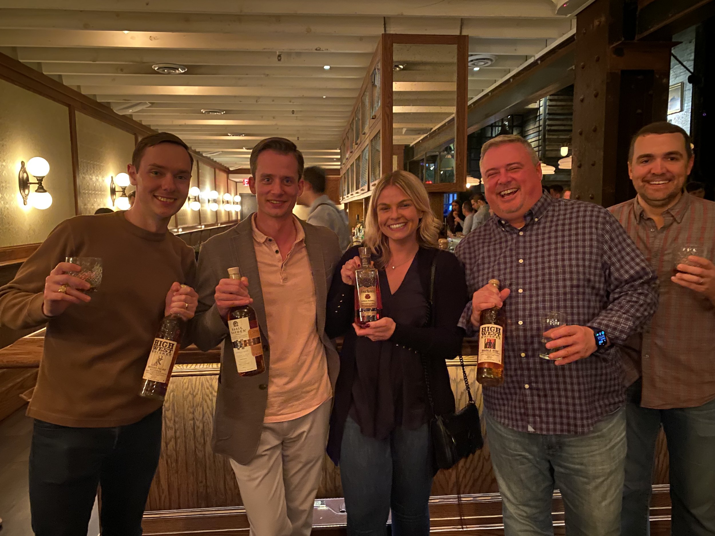 Members of the whiskey club smiling at an event