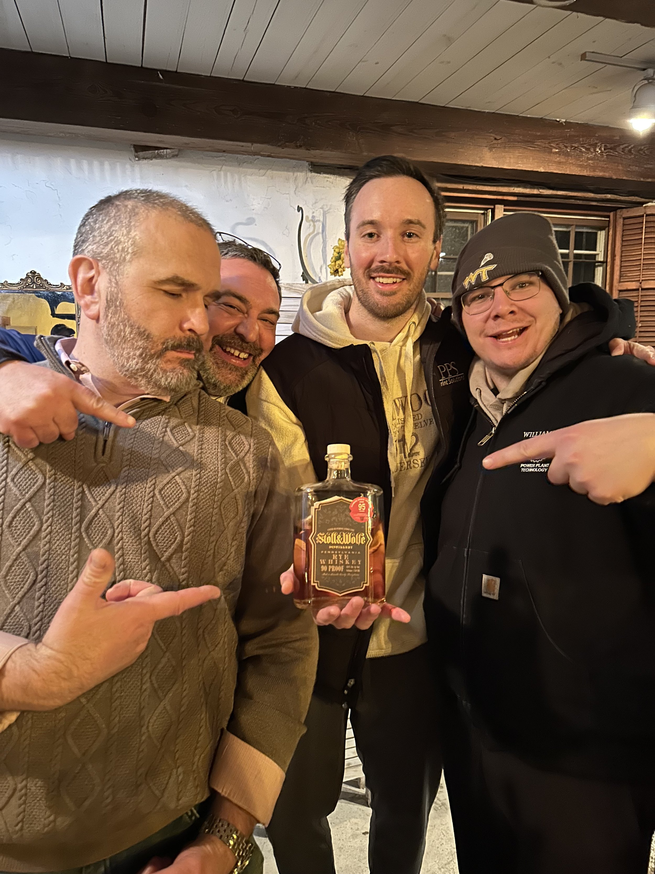 Members of the whiskey club smiling at an event