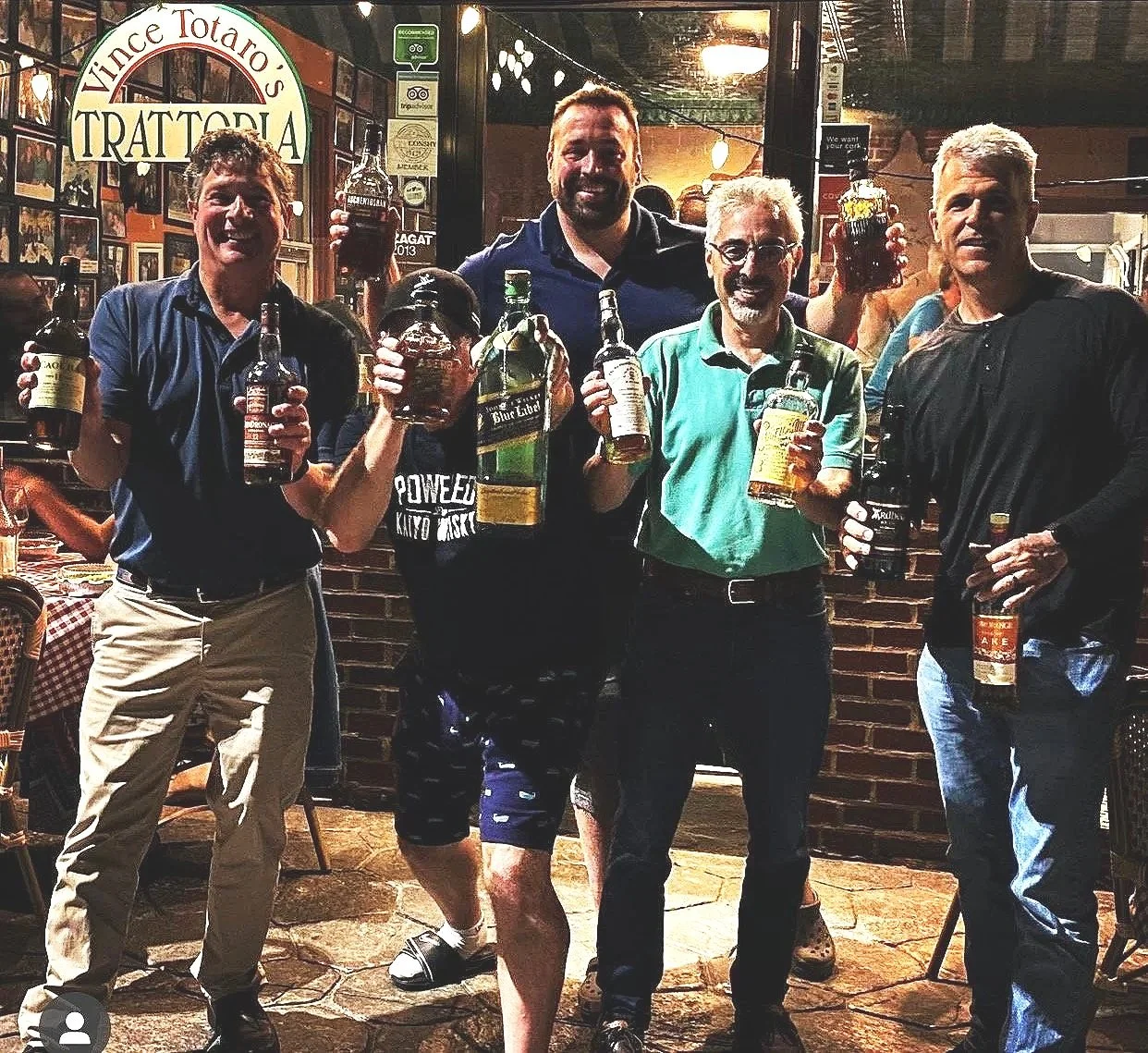 Members of the whiskey club smiling at an event