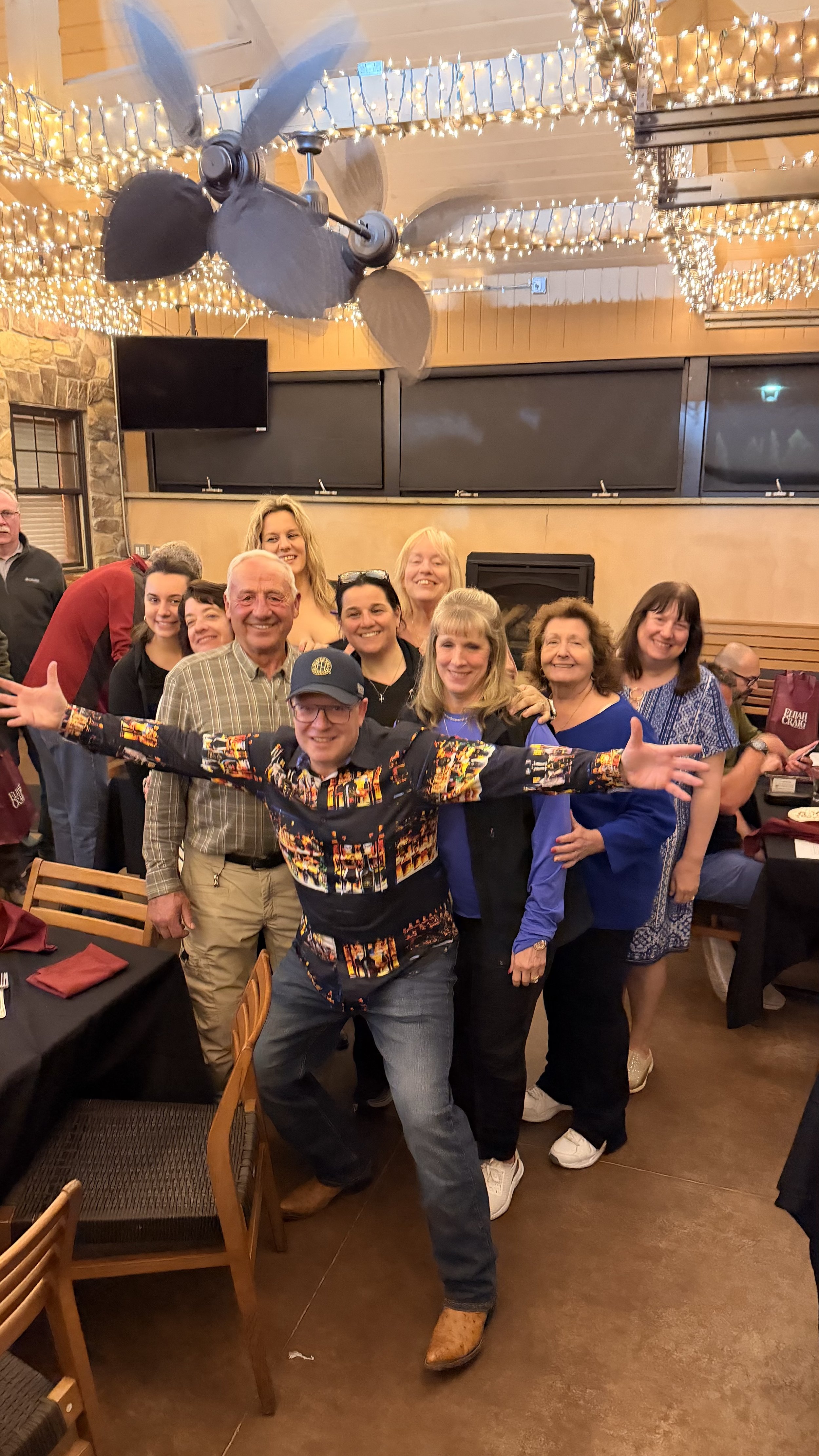 Mark Makers posing with members of the whiskey club smiling at an event