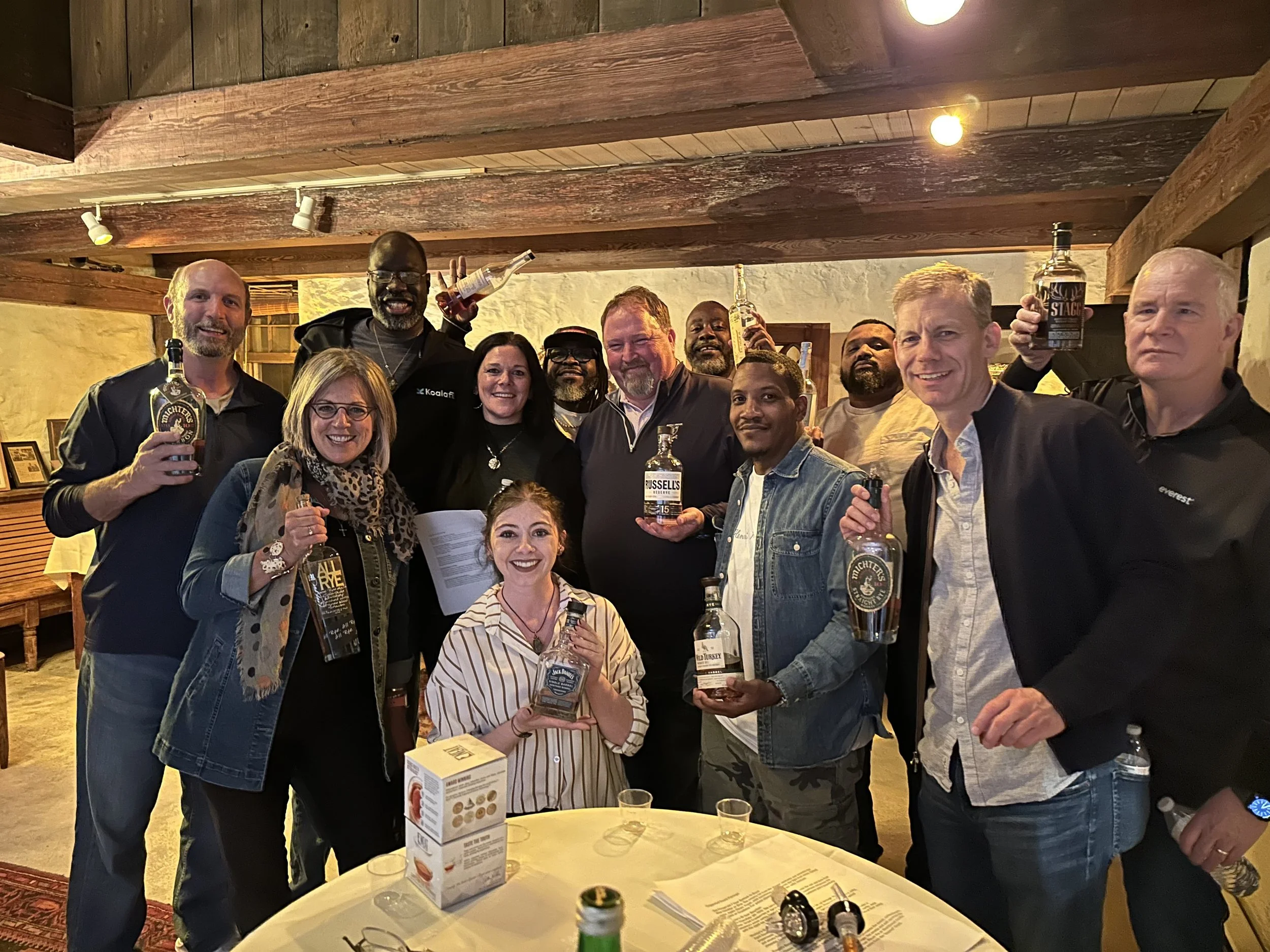 Members of the whiskey club smiling at an event