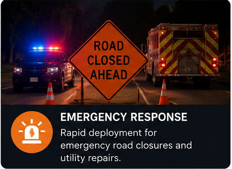 A road closed sign with police and fire trucks, cones, and emergency response information about road closures and utility repairs.