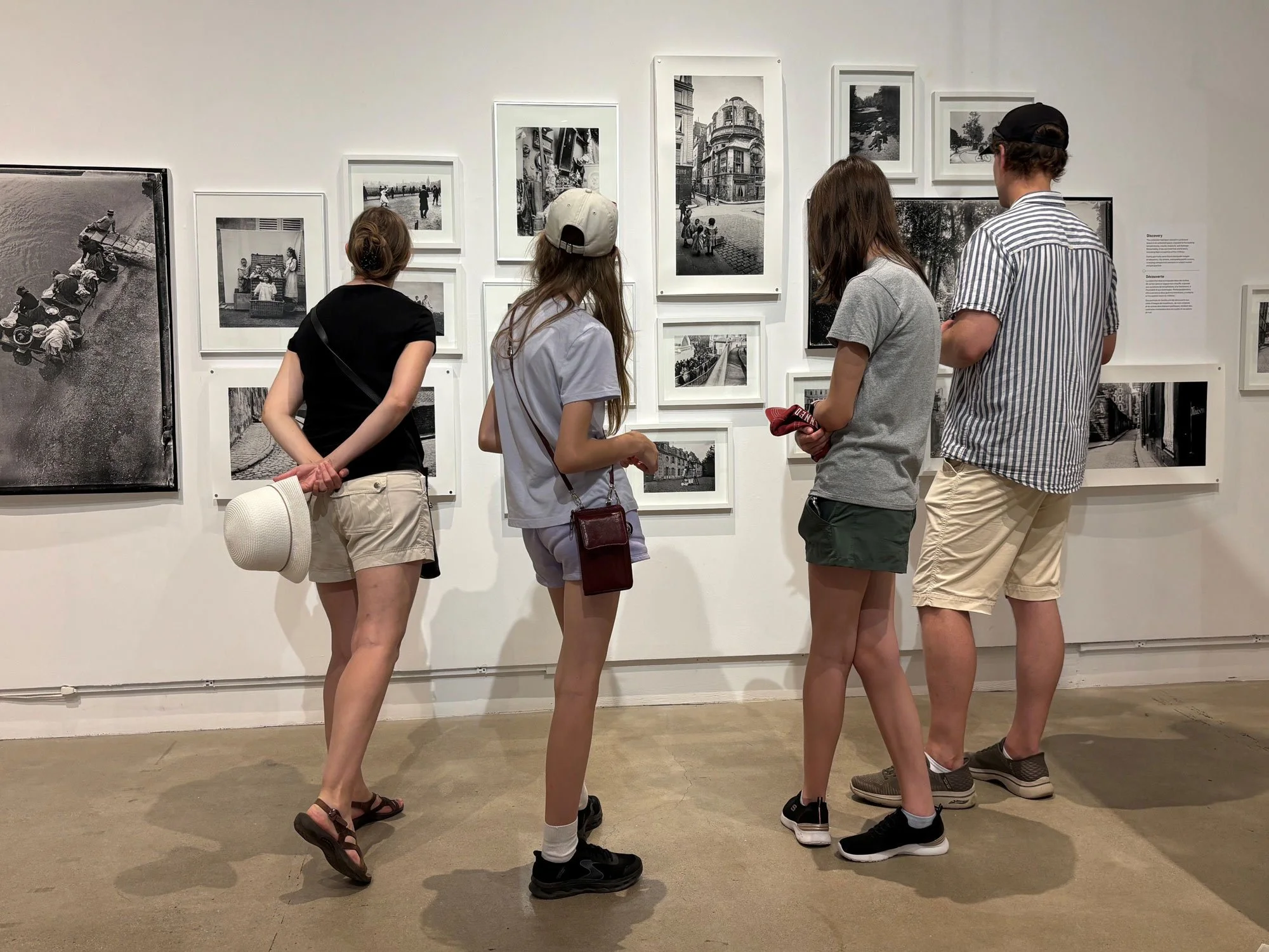 Family looking at framed photographs at Gallery Stratford exhibition