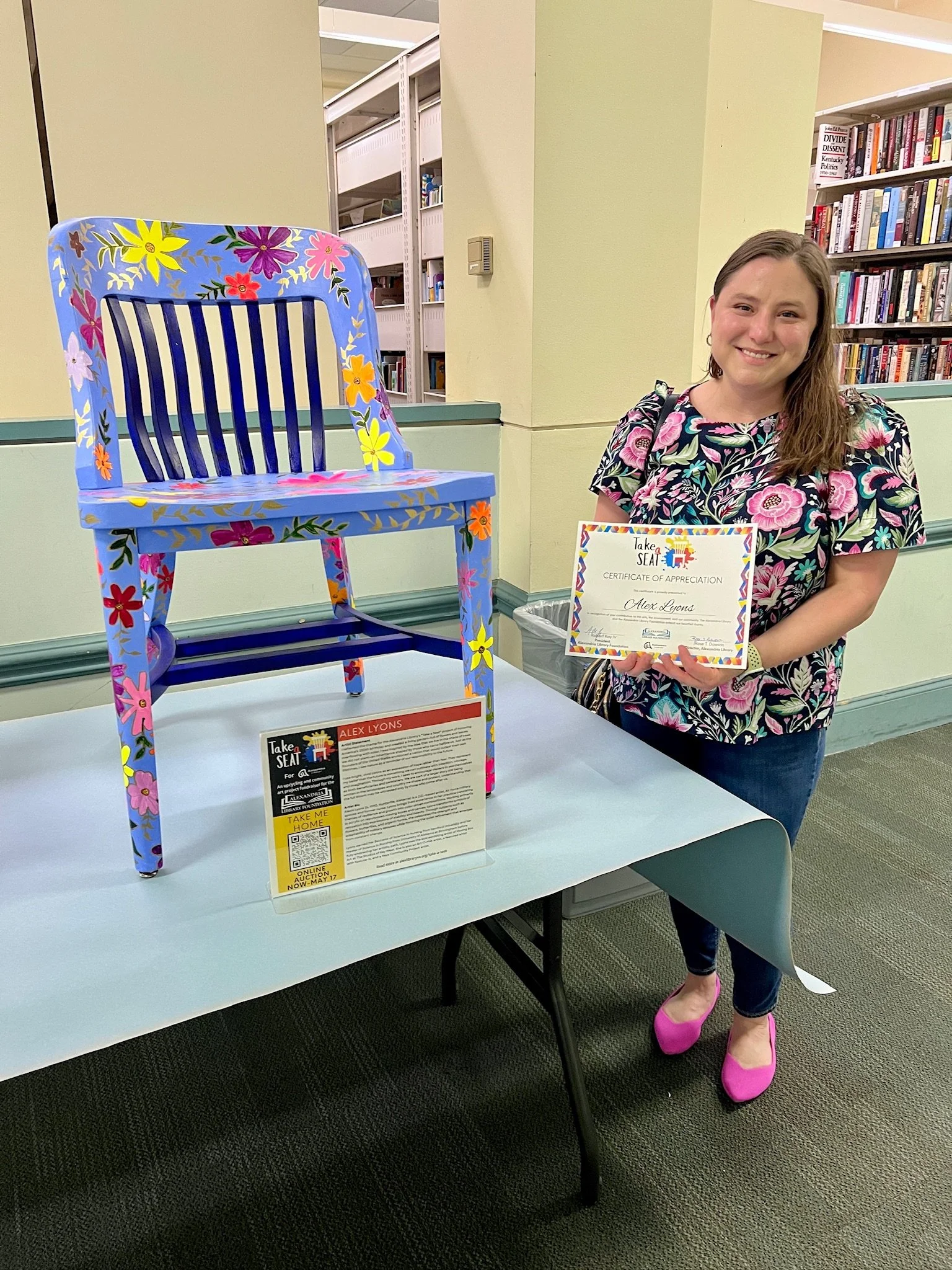 Image of the artist Alexis Lyons with her piece 250th Garden for the Take a Seat Project at the Alexandria Library.