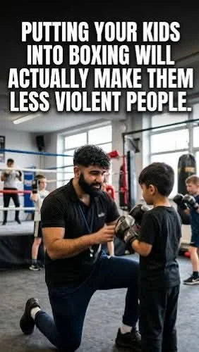 A boxing coach instructing a young boy in a boxing gym, with other children training in the background. The image includes the text: 'Putting your kids into boxing will actually make them less violent people.'